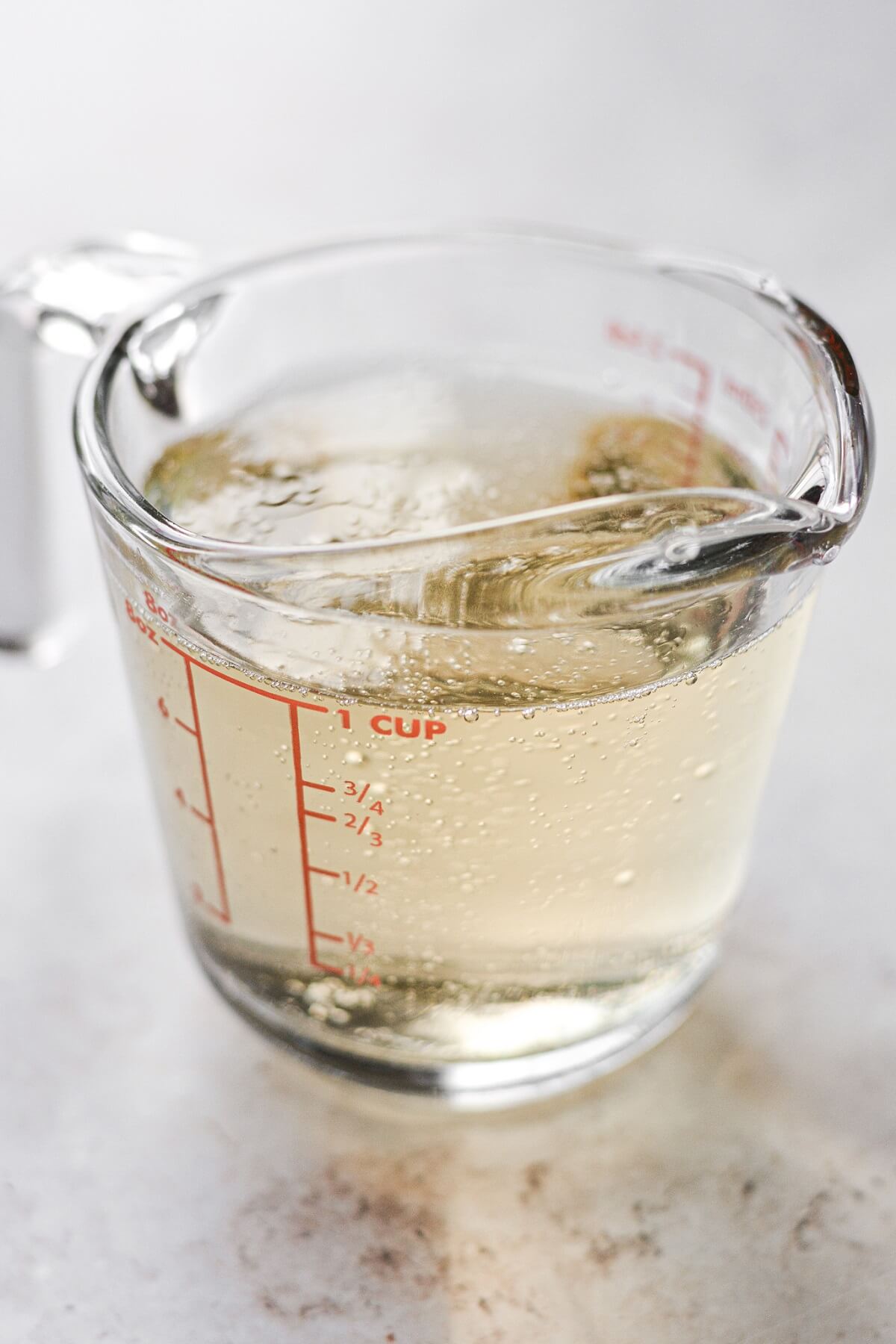 Champagne in a glass measuring cup.