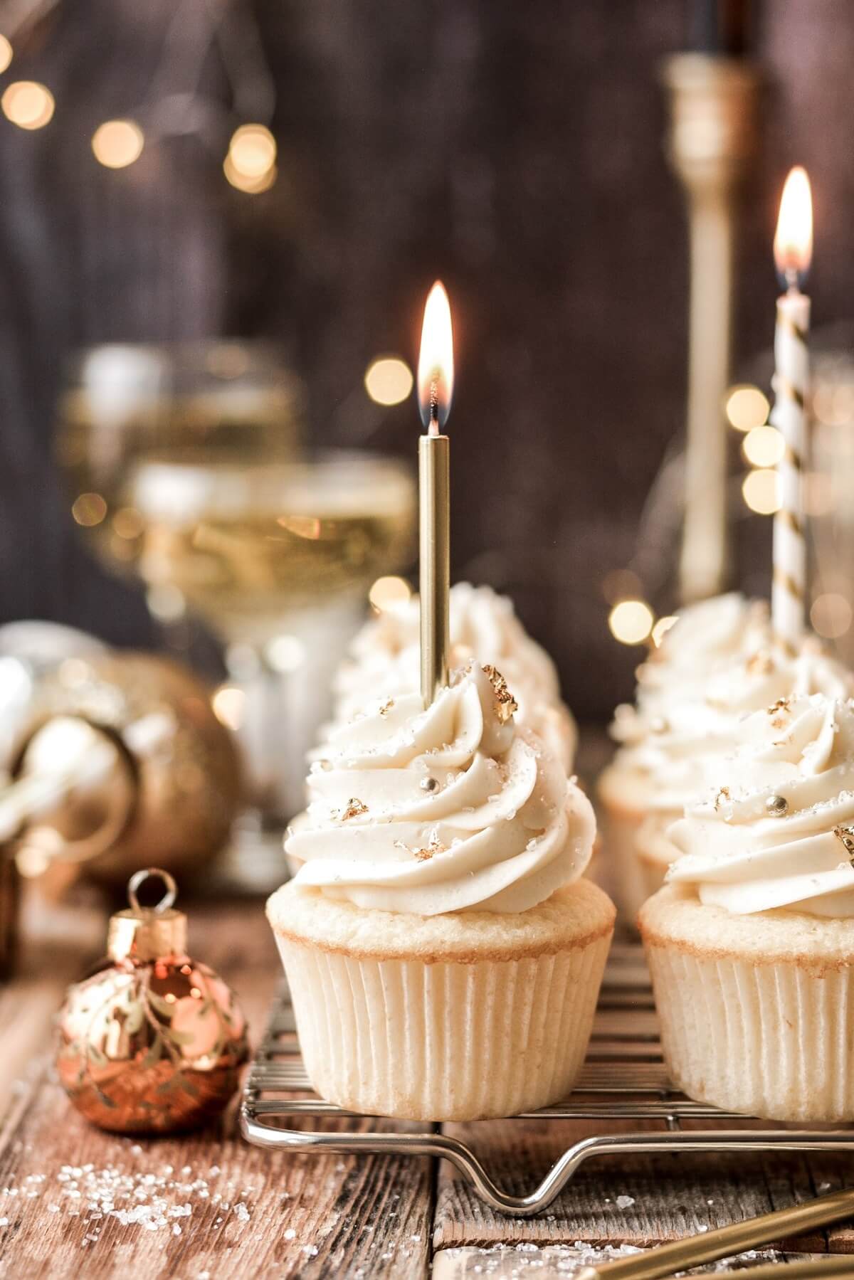 Champagne cupcakes topped with gold candles.