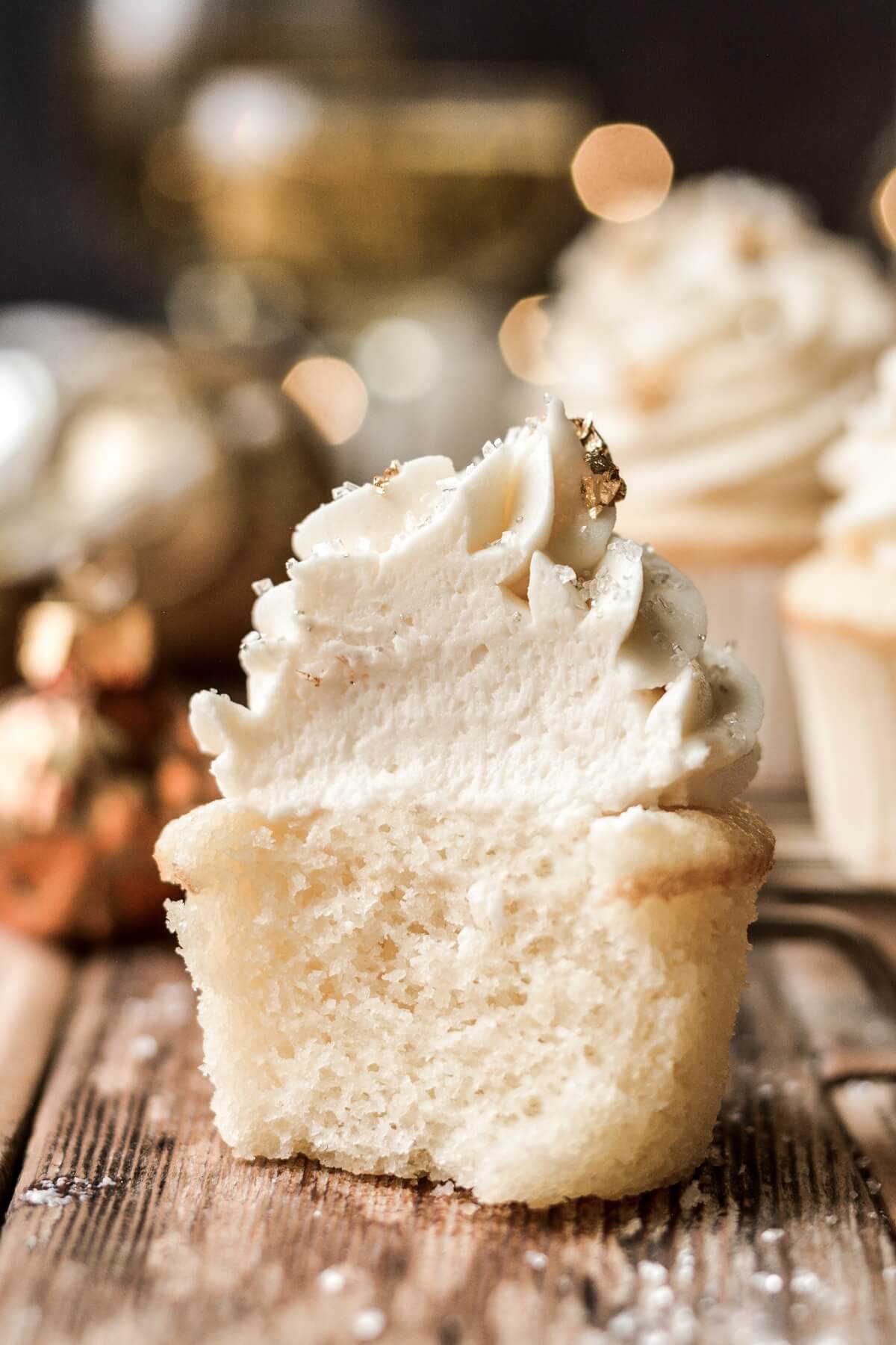 Champagne cupcake with a bite taken.