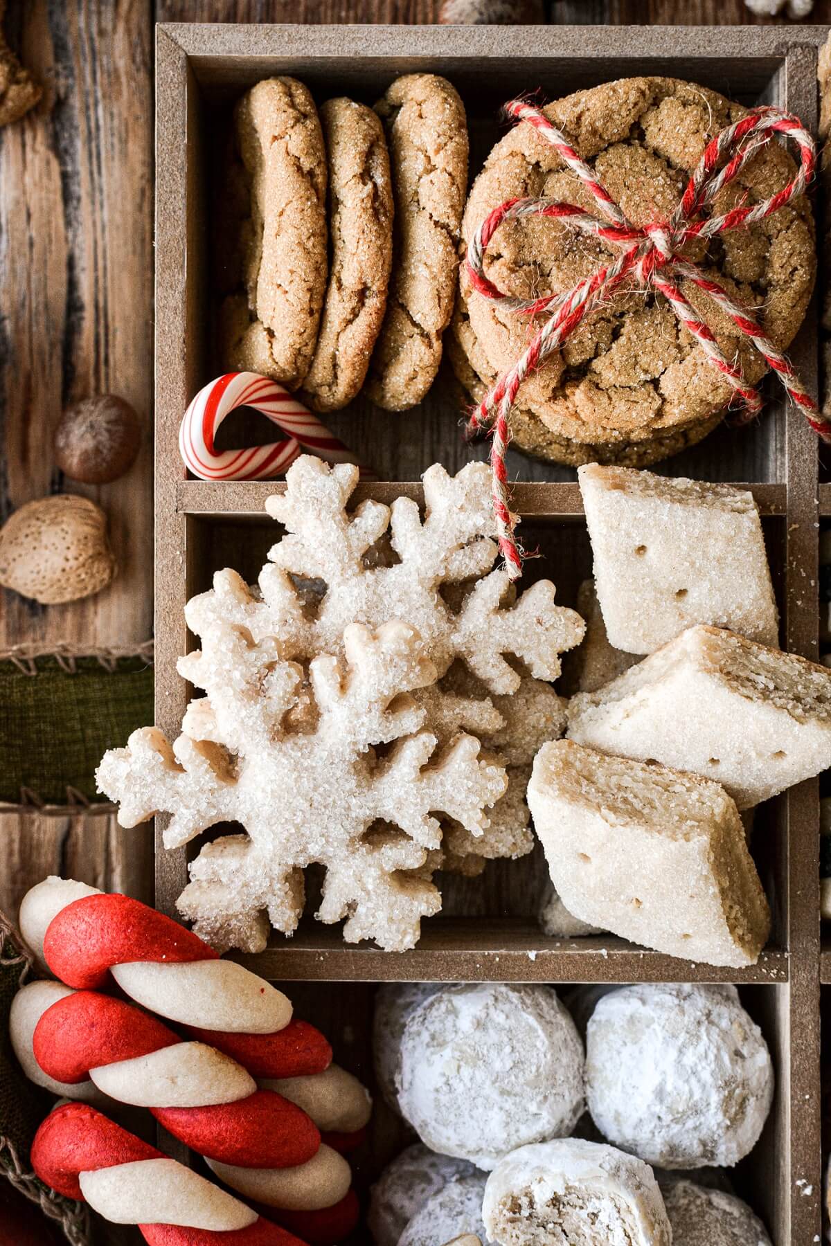 Box full of ginger molasses cookies, snowflakes, almond shortbread and candy cane cookies.