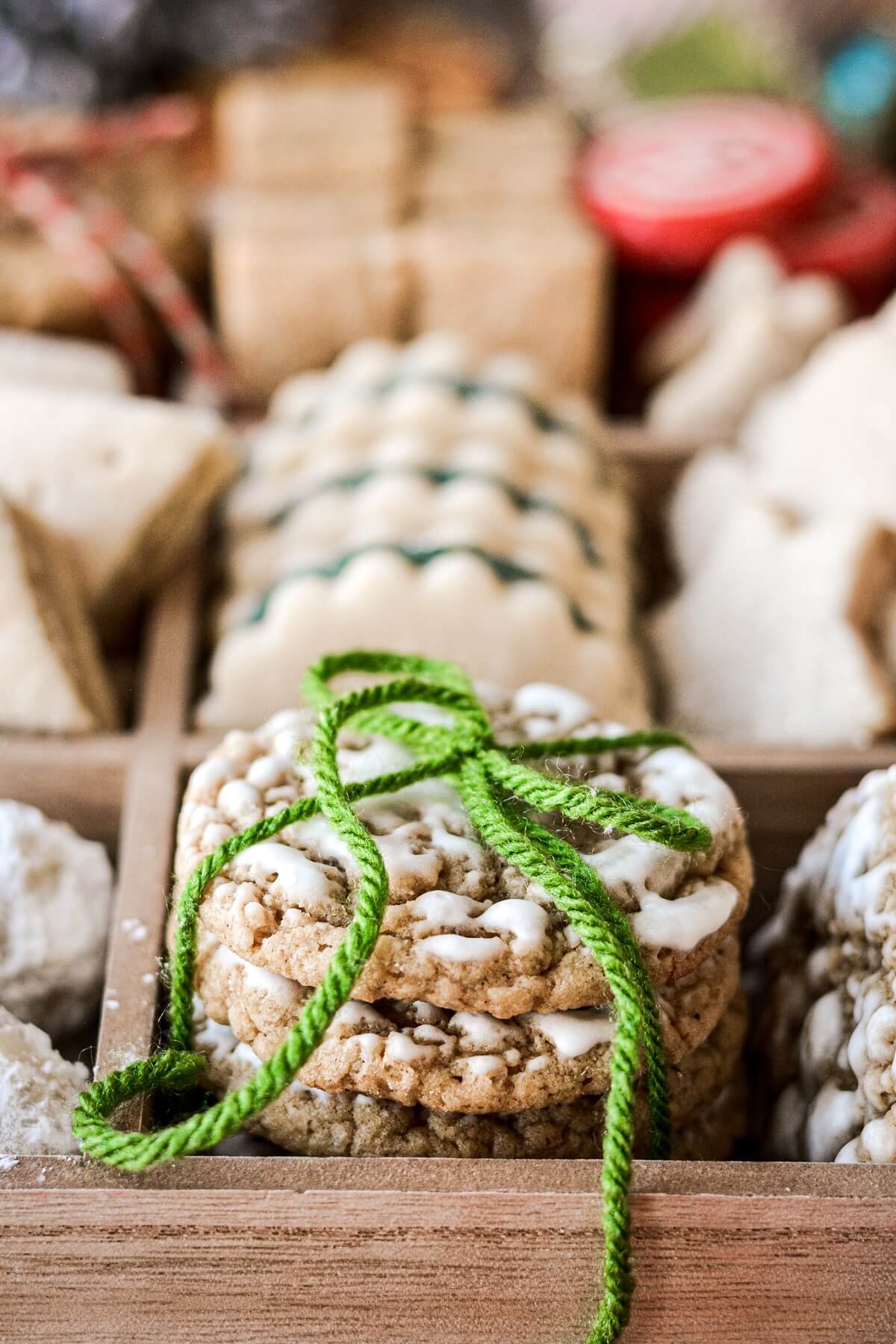 Stack of iced oatmeal cookies tied with green twine.