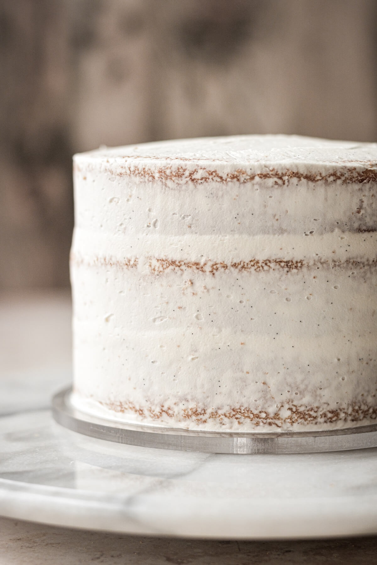 Cake with a crumb coat of buttercream.