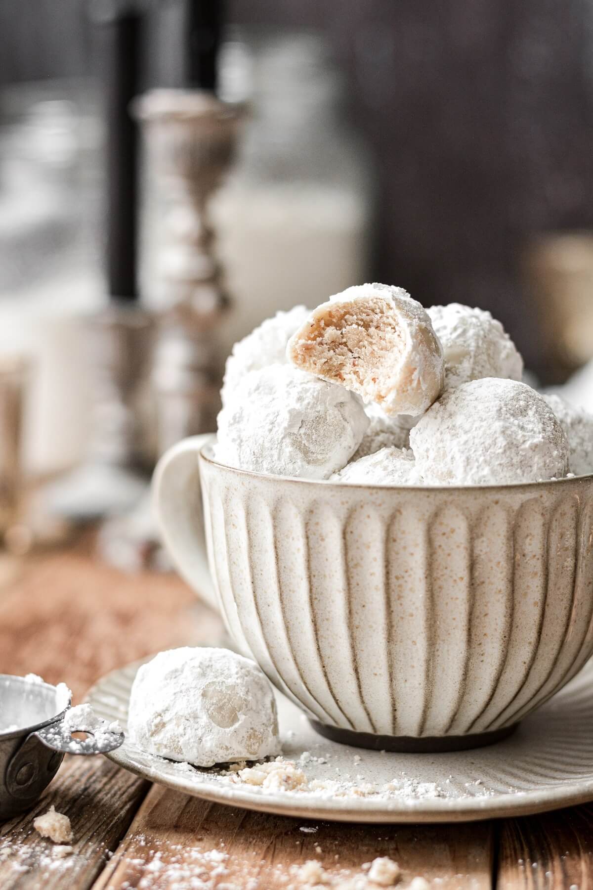 Snowball cookies arranged in a coffee cup.