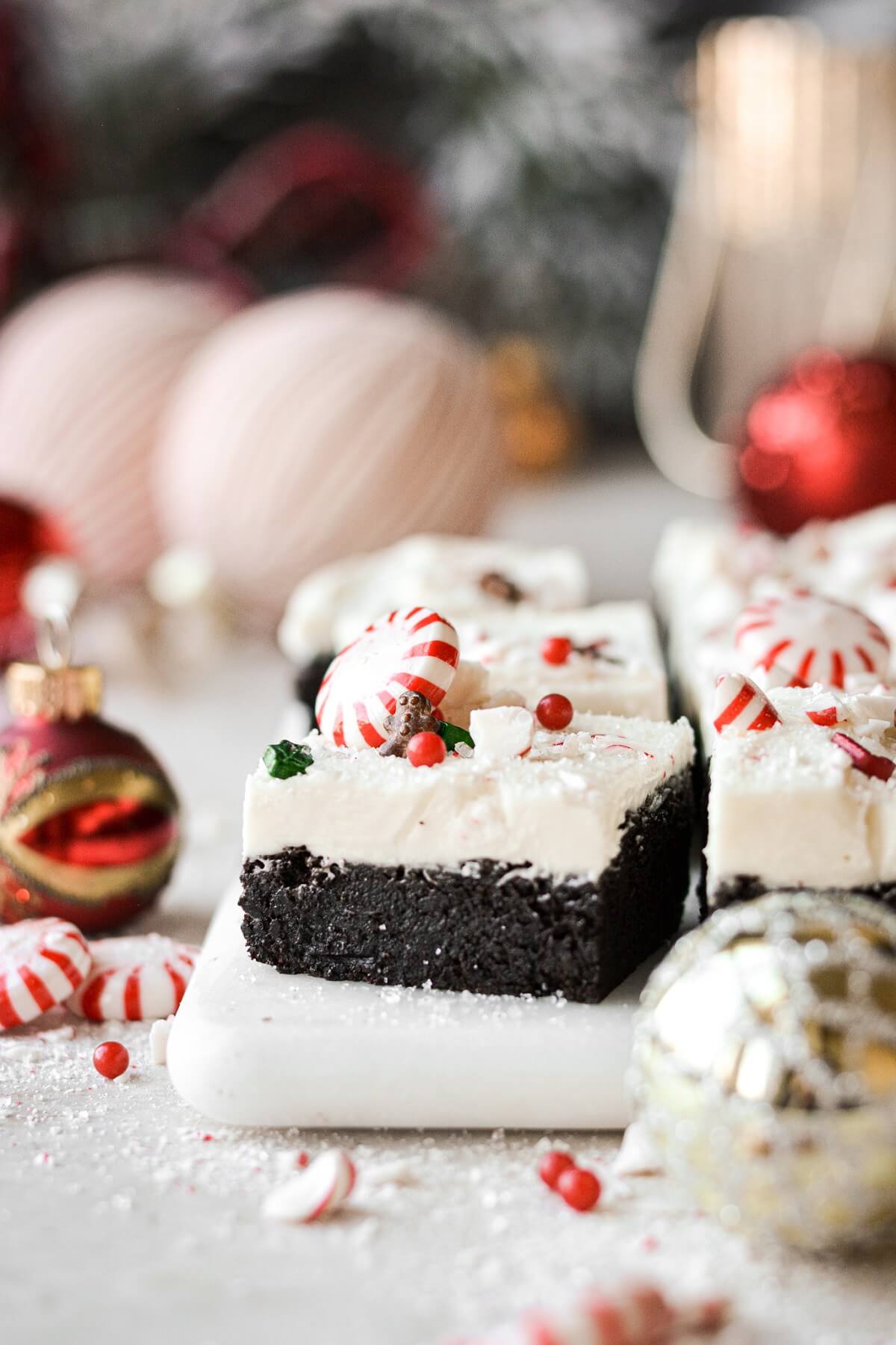 Frosted peppermint brownies topped with sprinkles.
