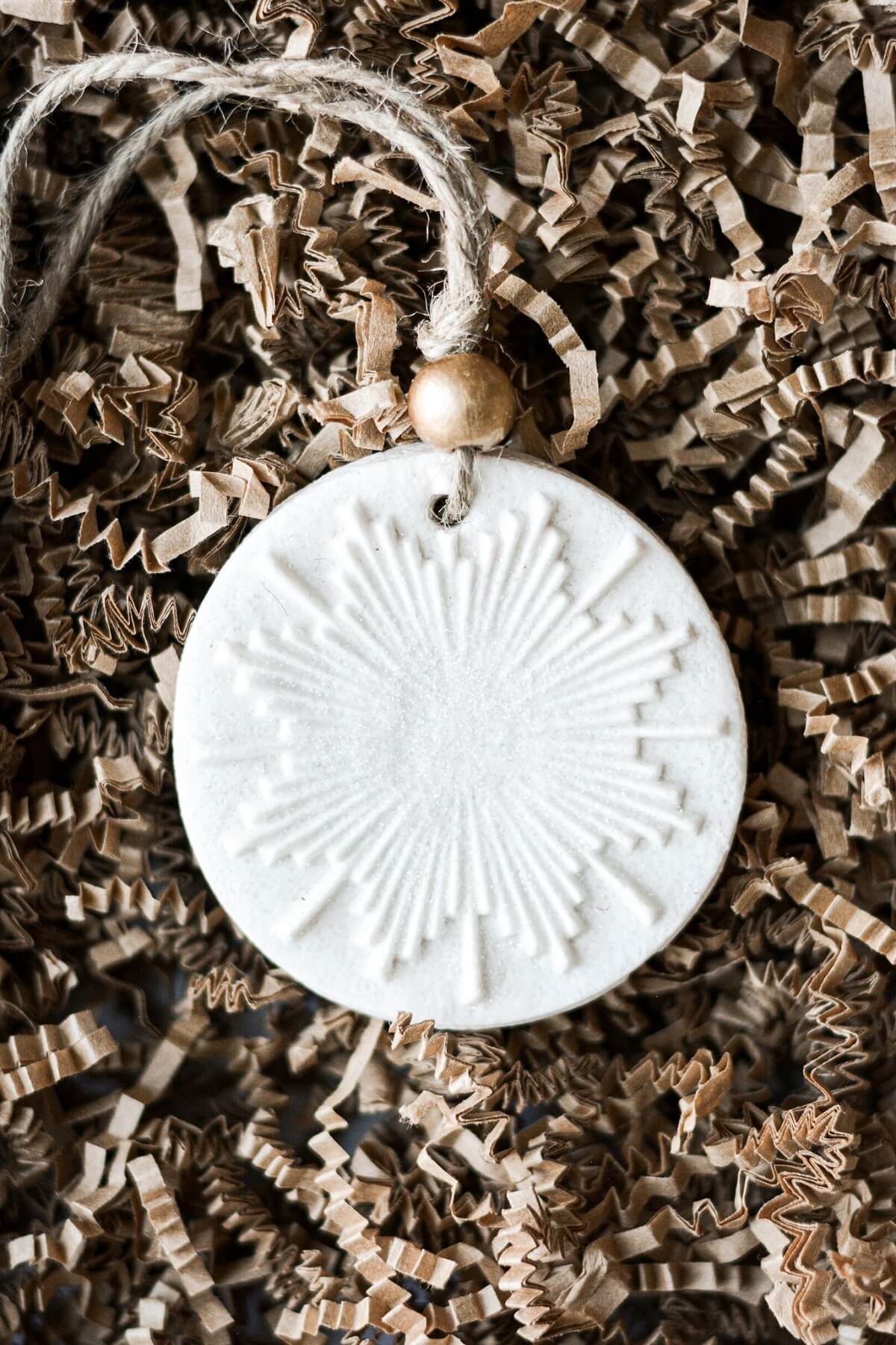 Salt dough Christmas ornament on crinkled paper.