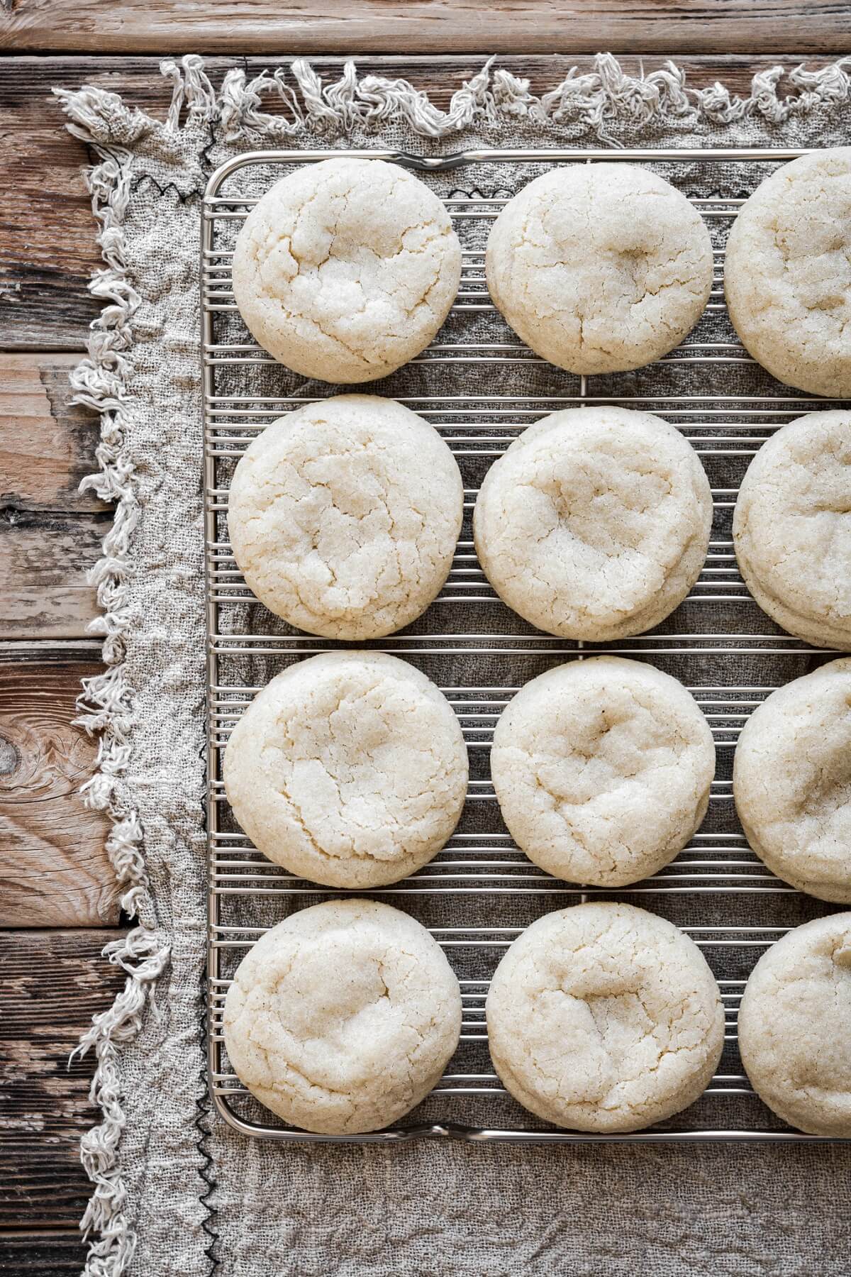 Soft eggnog cookies on a cooling rack.