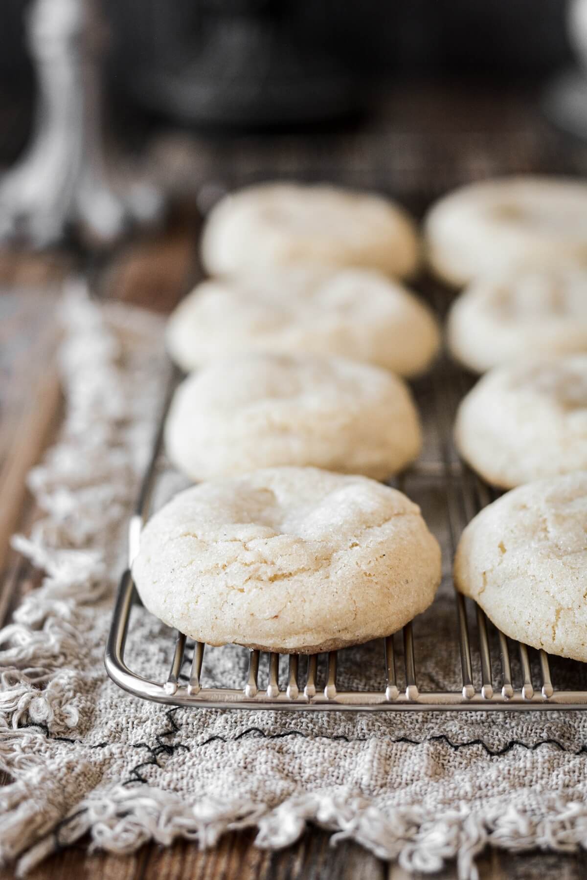 Soft fluffy eggnog cookies on a cooling rack.
