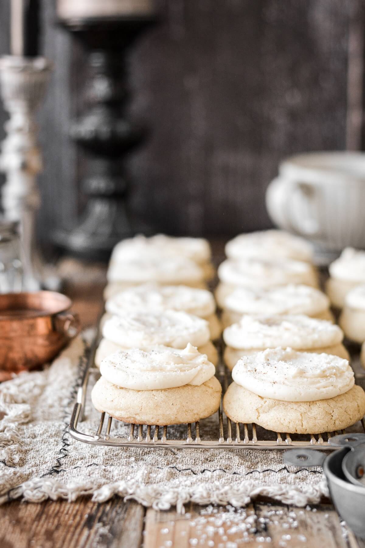 Frosted eggnog cookies on a cooling rack.