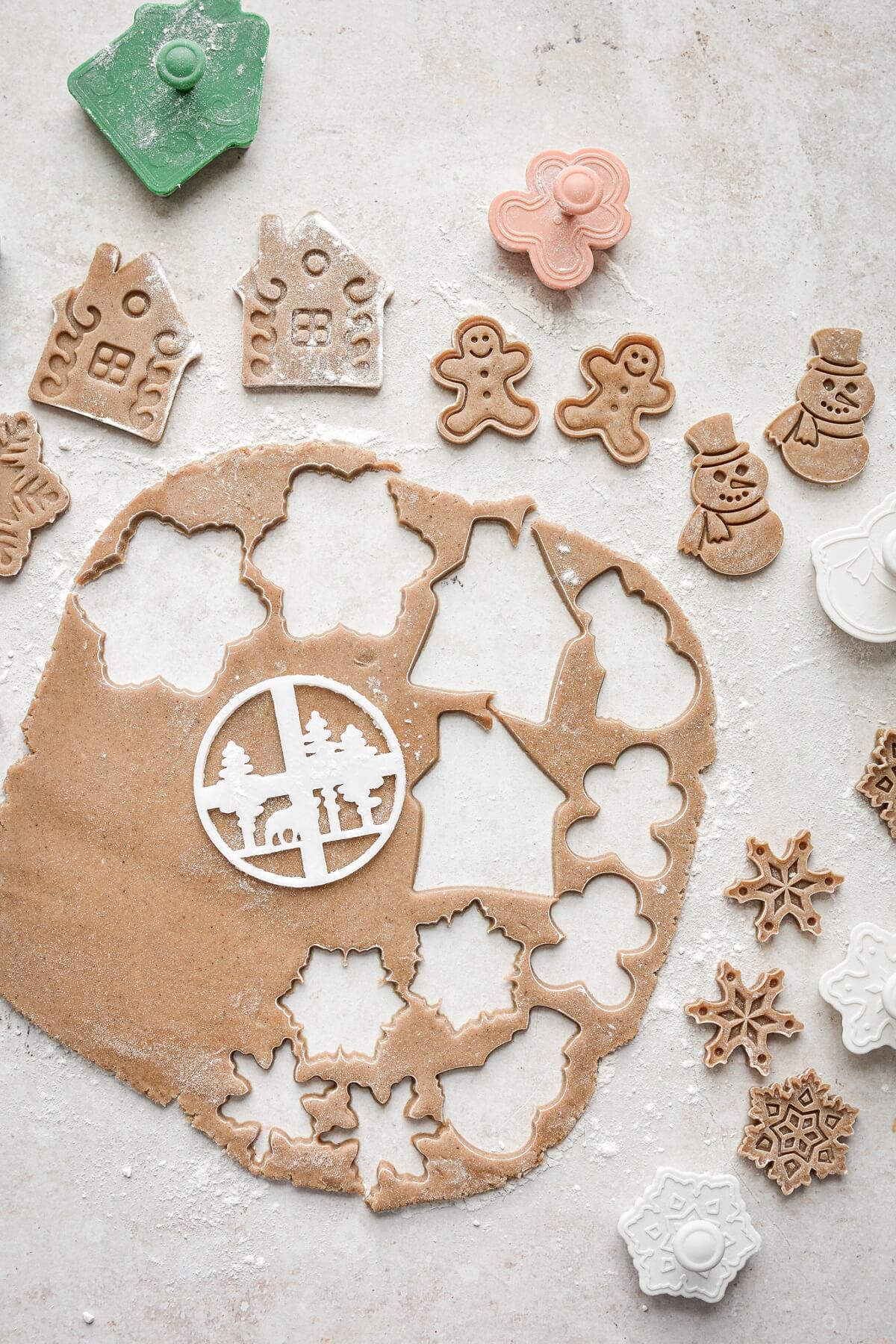 Gingerbread cookie dough cut with cookie cutters.
