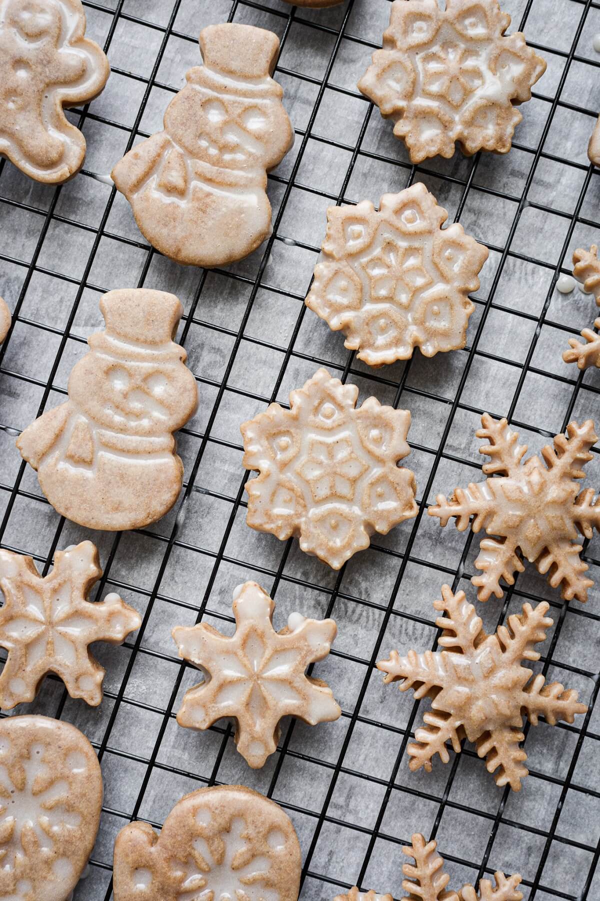 Iced gingerbread cookies on a cooling rack.