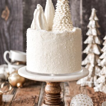 White Christmas cake topped with ice cream cone Christmas trees.