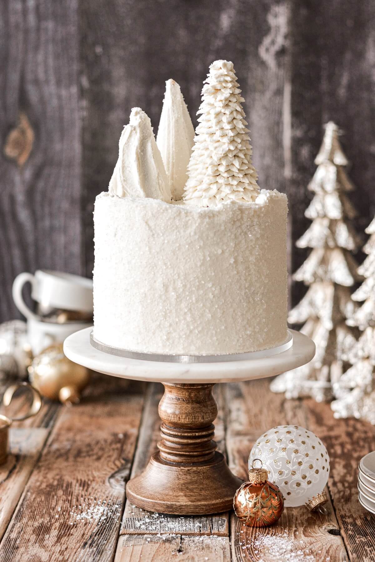 White Christmas cake topped with ice cream cone Christmas trees.