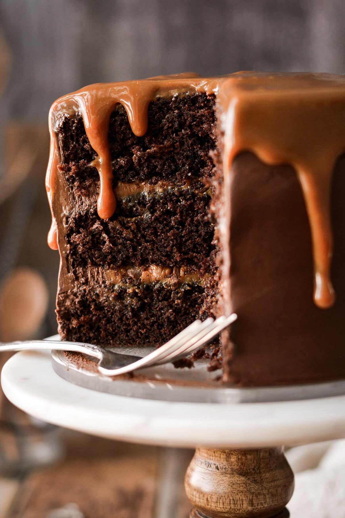 Chocolate caramel toffee cake with a slice cut.