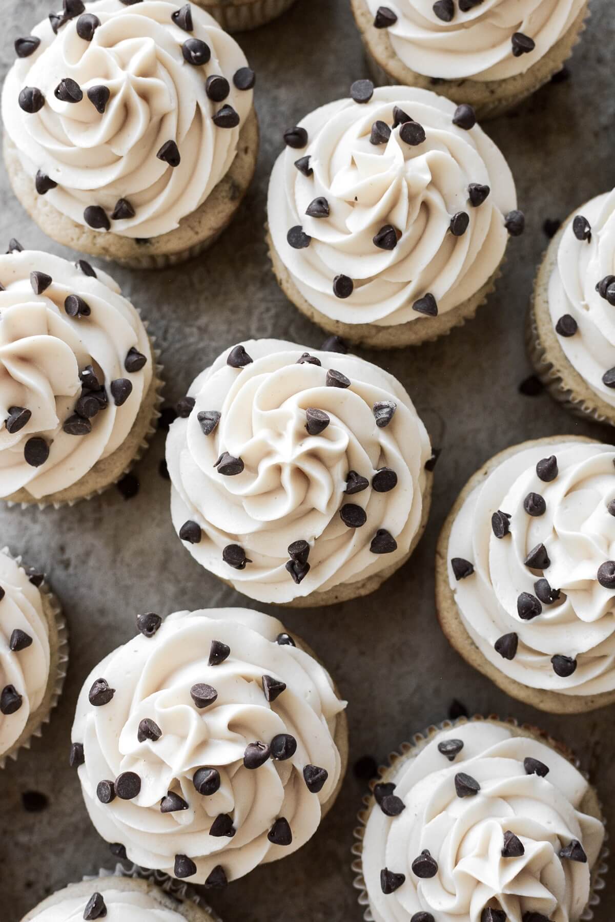Mini chocolate chips sprinkled on top of cupcakes.