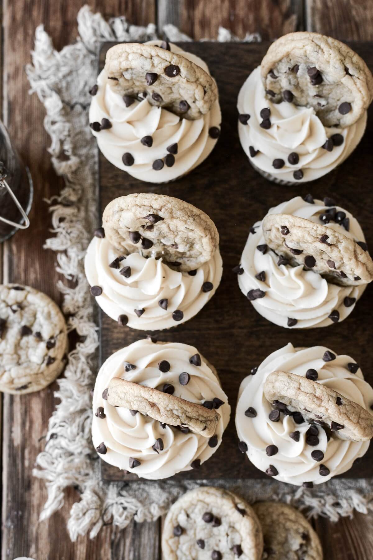 Chocolate chip cupcakes topped with cookies.