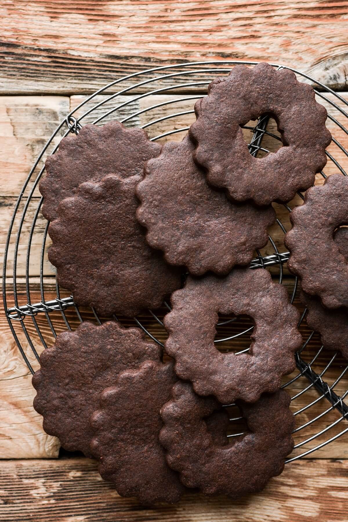 Cutout chocolate sugar cookies on a cooling rack.