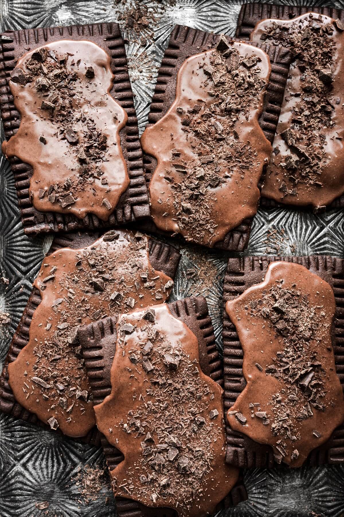 Frosted chocolate fudge pop tarts sprinkled with chopped chocolate.