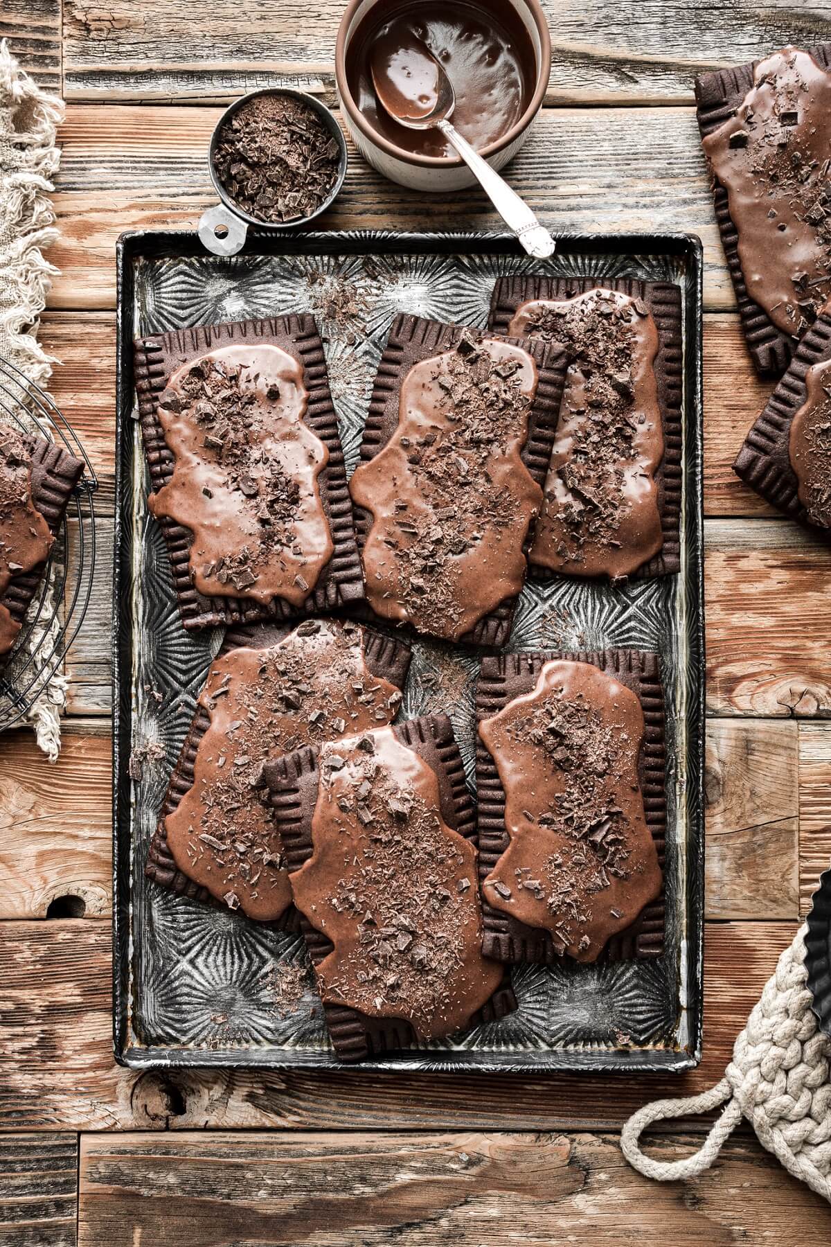 Chocolate fudge pop tarts on a baking sheet.