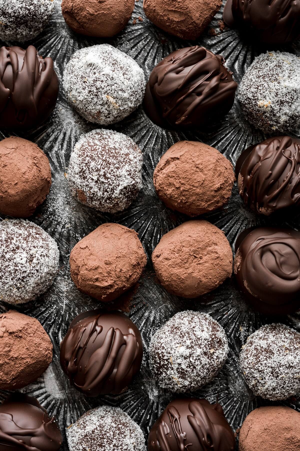 Chocolate truffles with cocoa powder, orange sugar and chocolate coating.