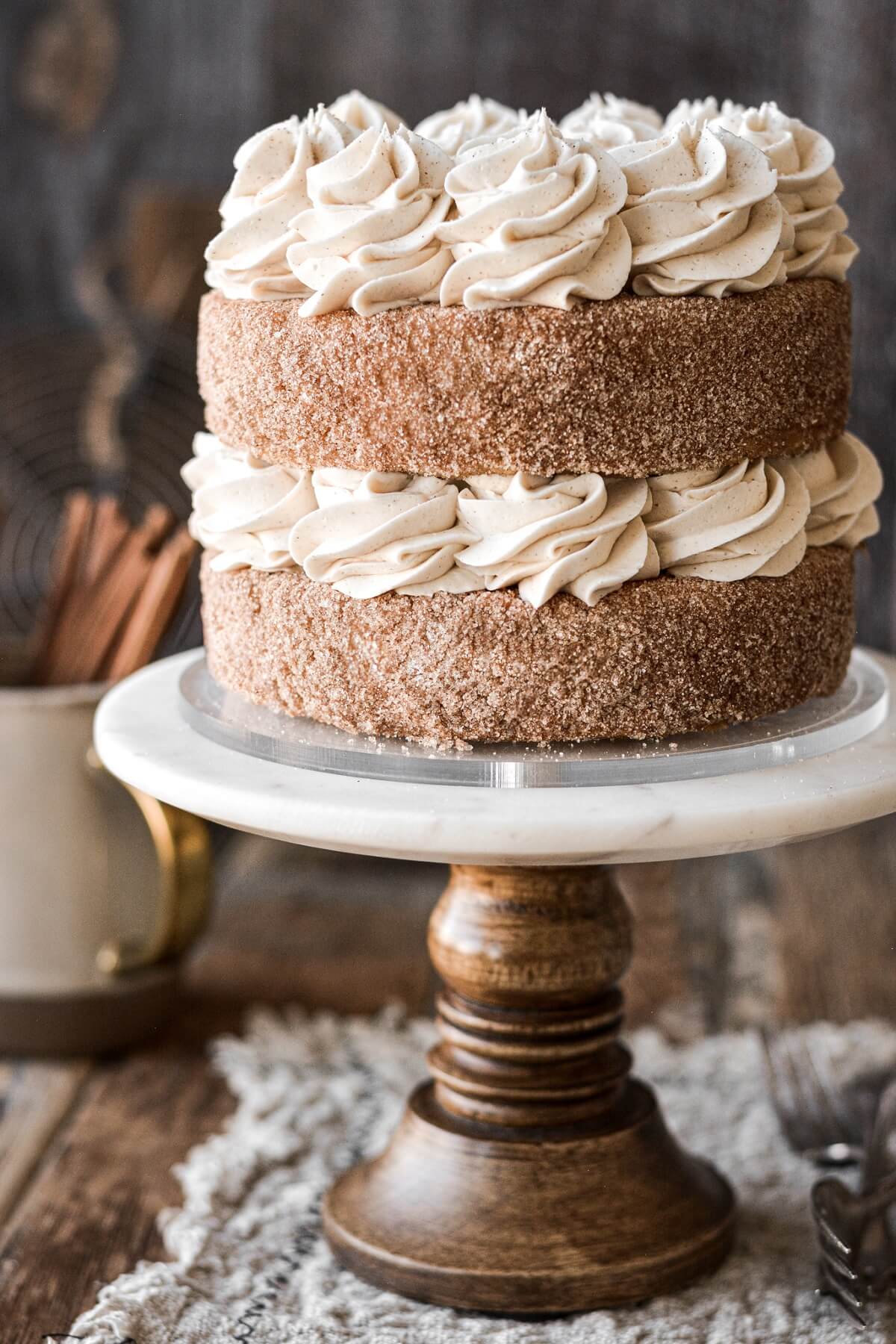 Piped buttercream between layers of cinnamon cake.