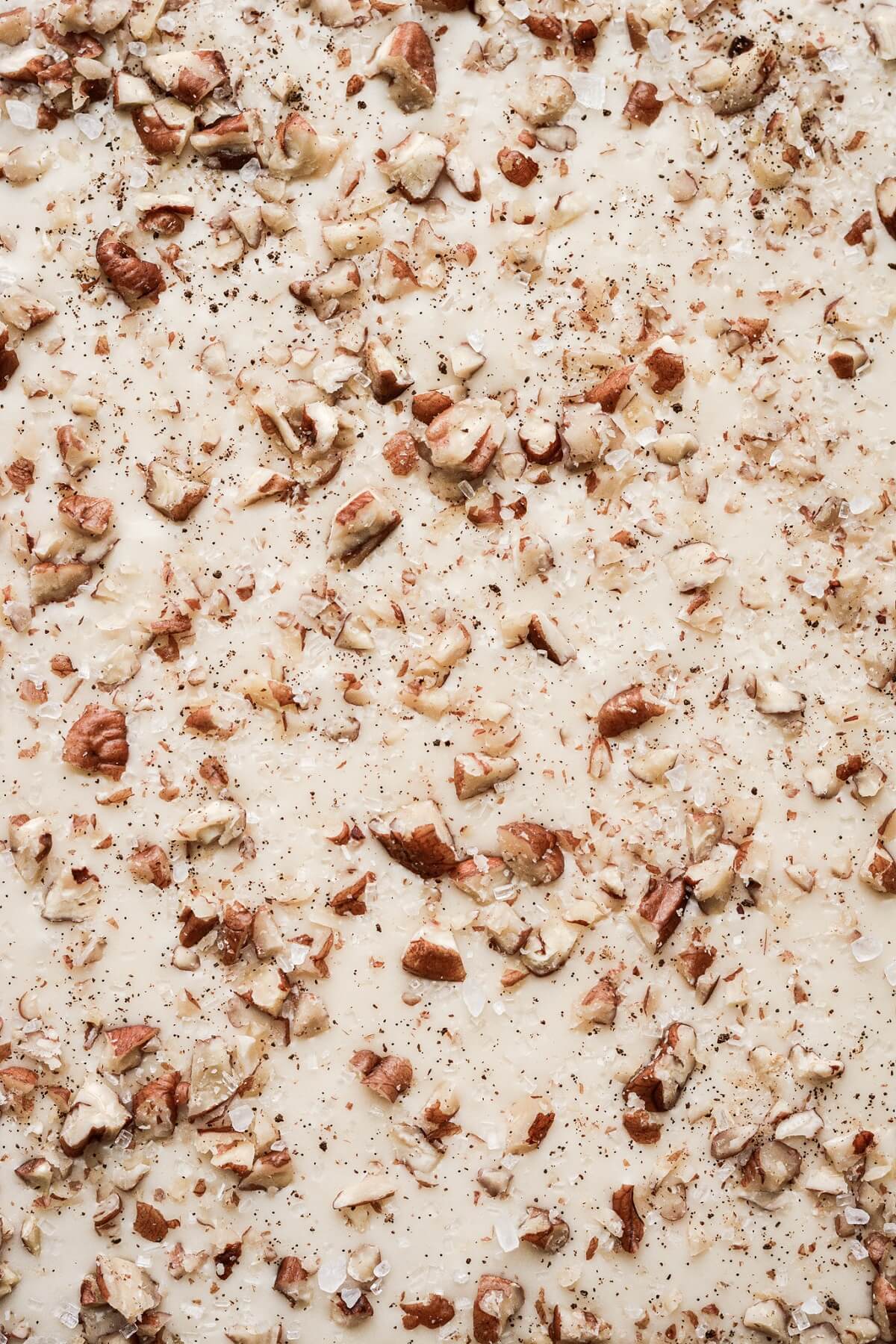 Eggnog icing sprinkled with chopped pecans.