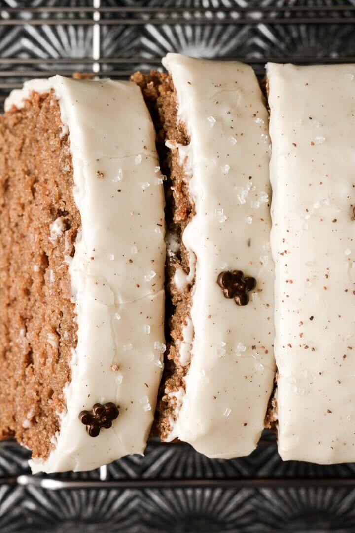 Slices of gingerbread loaf cake with eggnog icing.