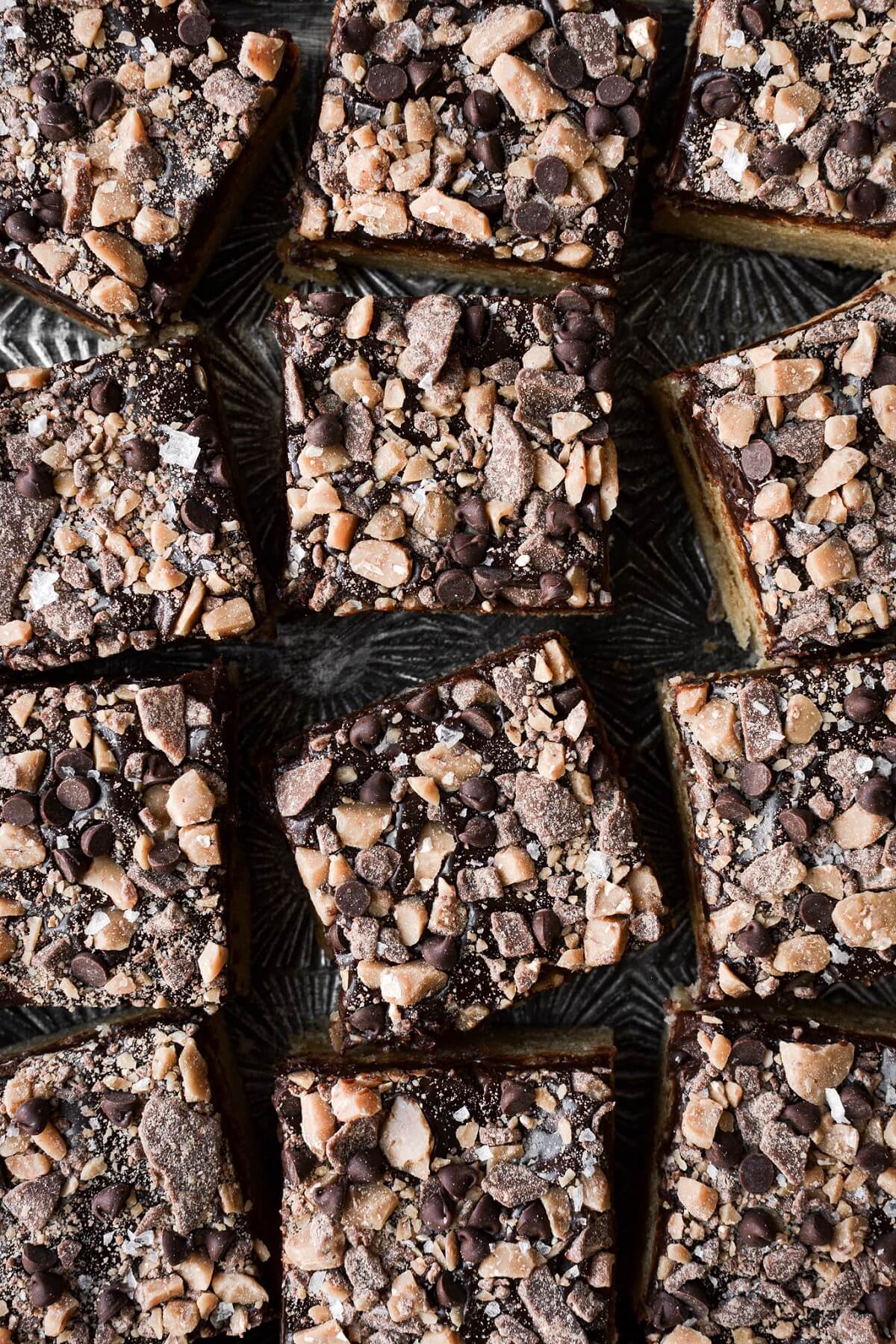Blondies with ganache and toffee, cut into squares.
