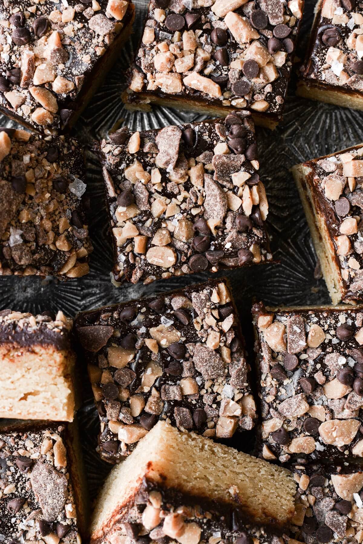 Blondies with ganache and toffee, cut into squares.