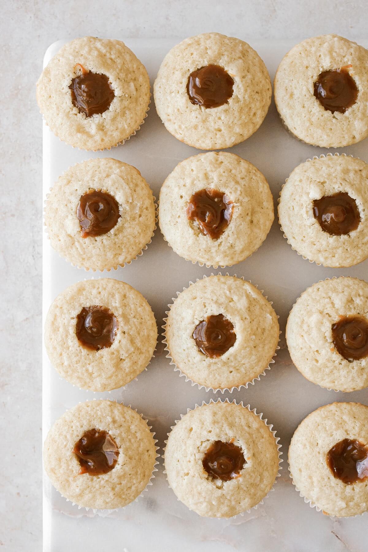 Coconut cupcakes filled with caramel.