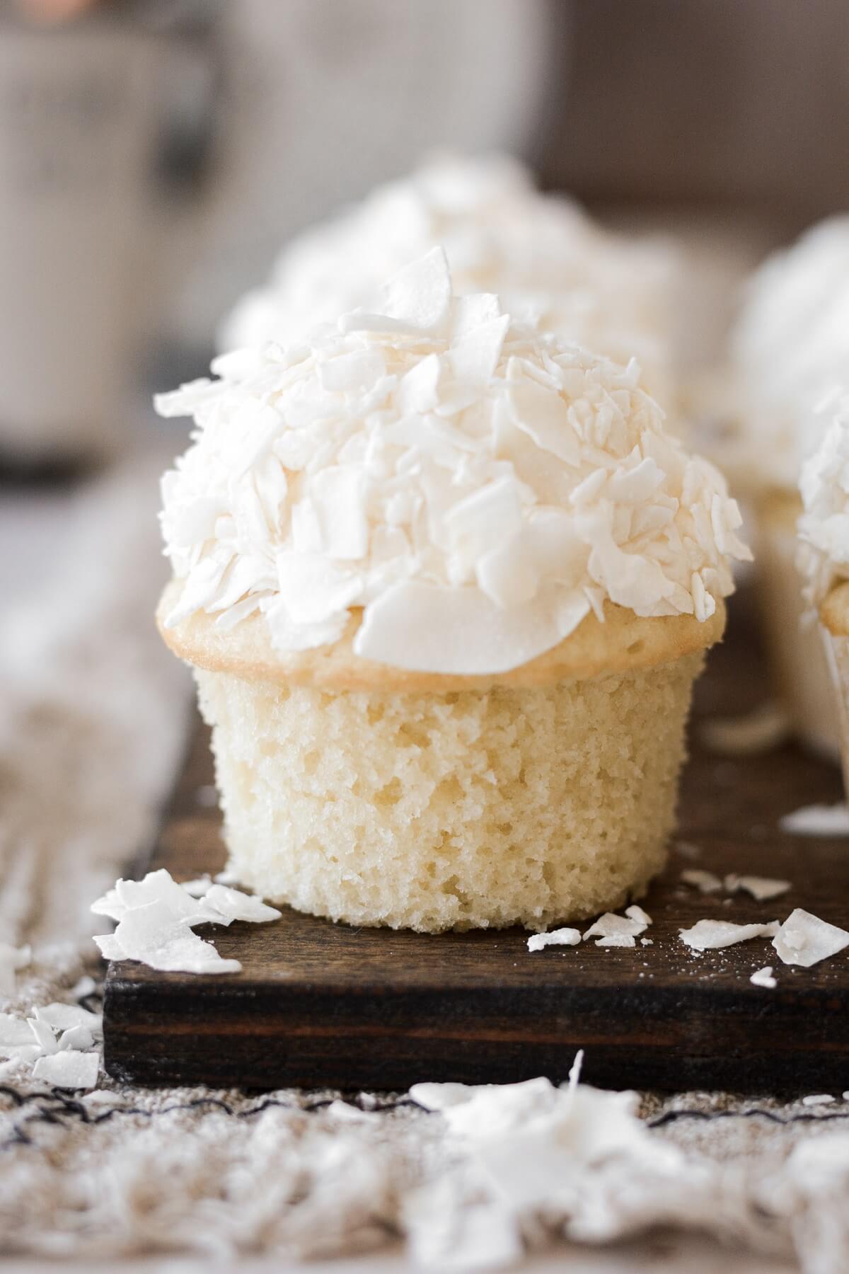 Coconut cupcake with the wrapper pulled off.