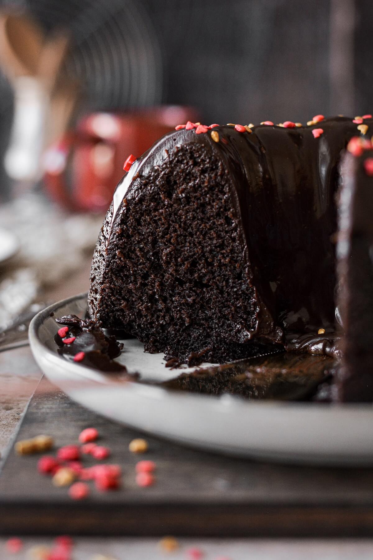 Chocolate bundt cake with a slice cut.
