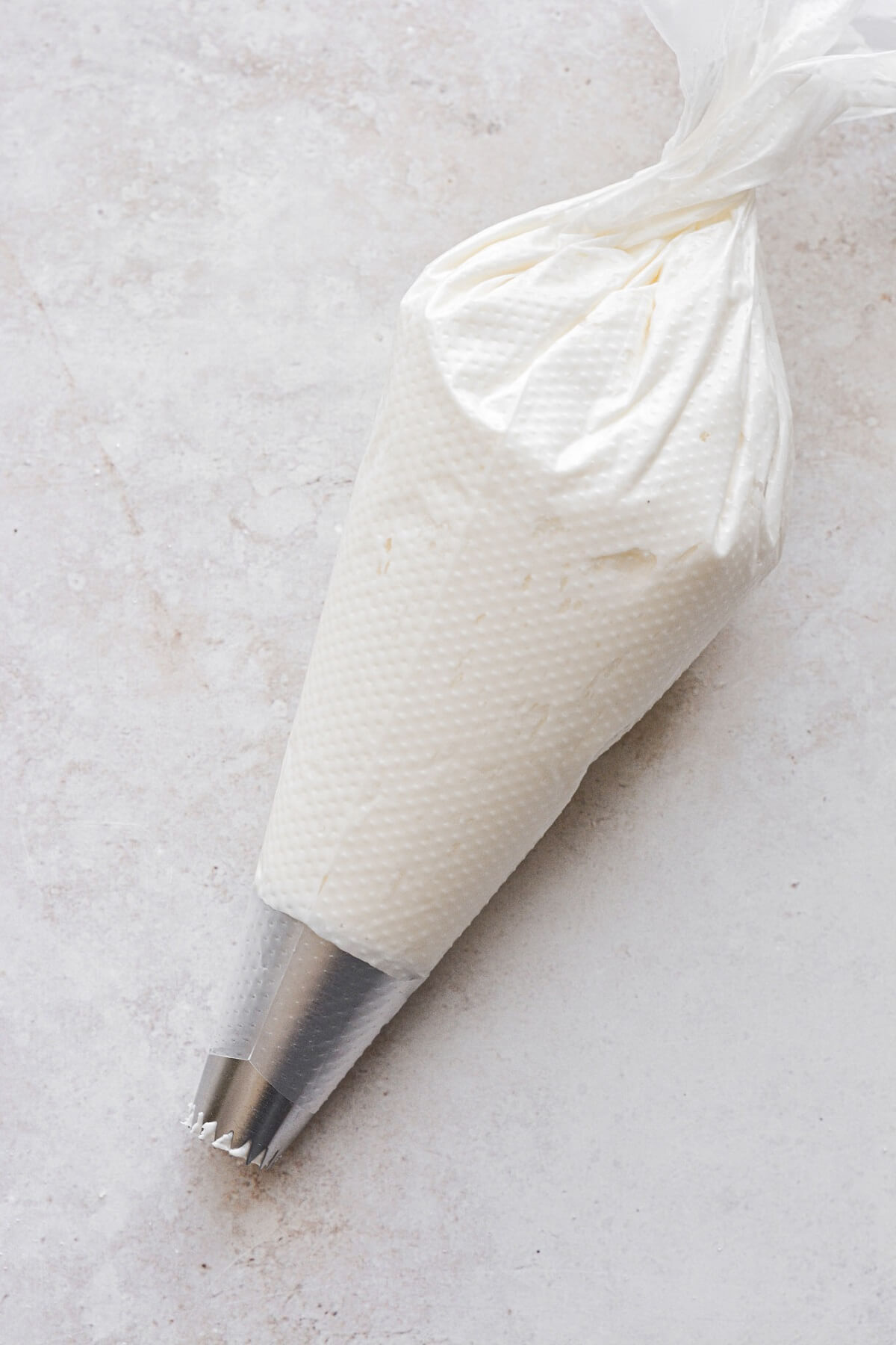 Piping bag filled with lemon cream cheese buttercream.