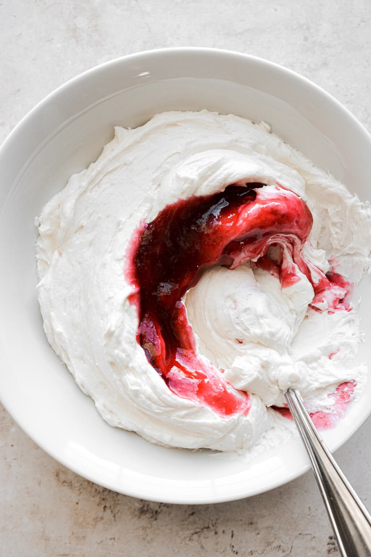Raspberry jam swirled into vanilla buttercream.