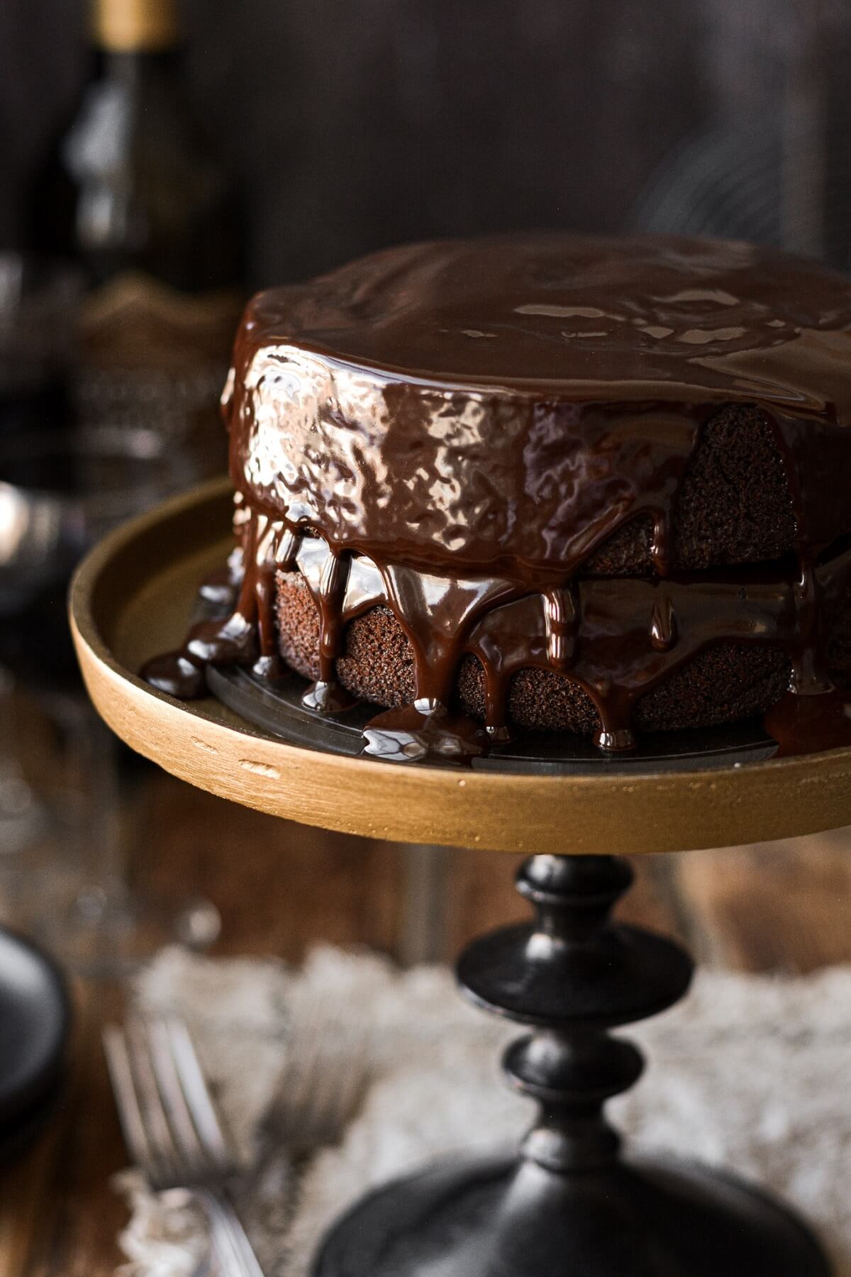 Ganache dripping on top of a red wine chocolate cake.