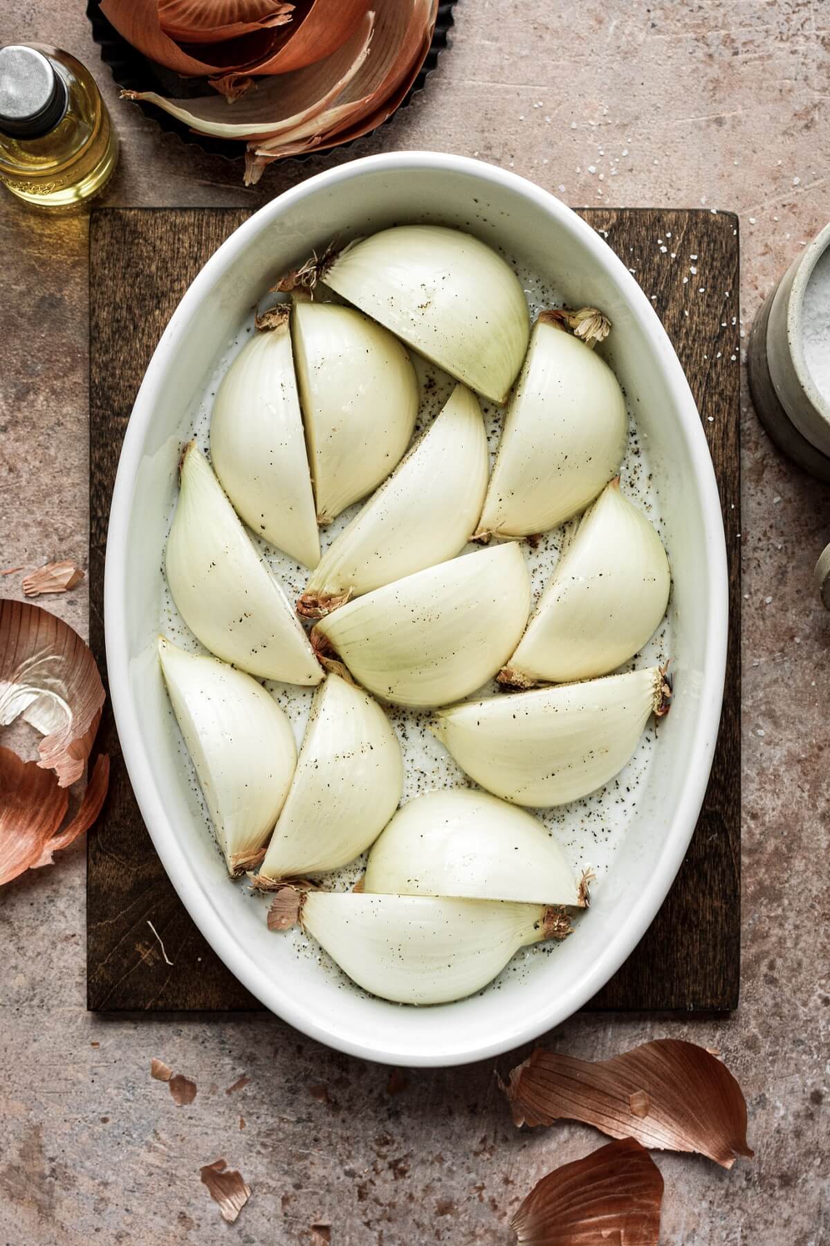 Quartered onions in a baking dish.