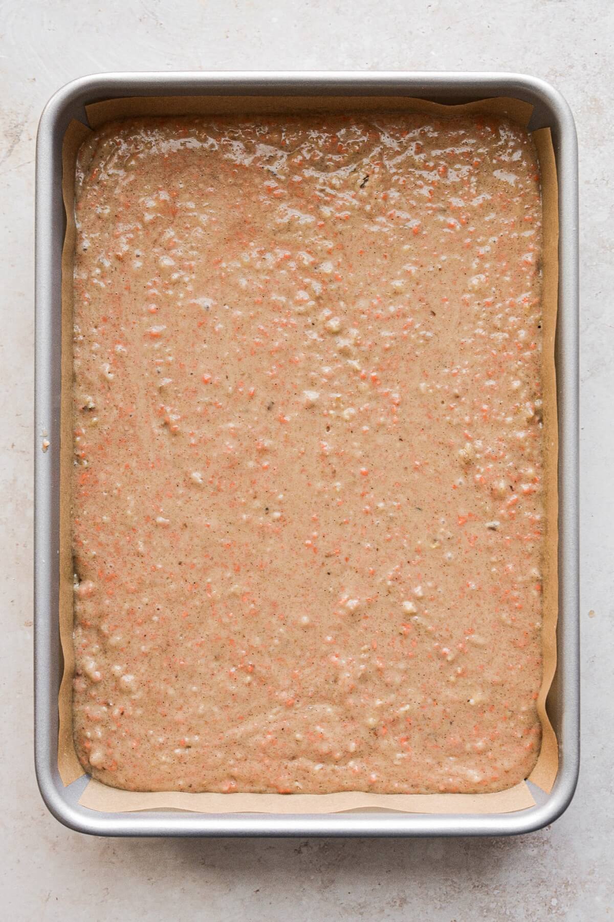 Sheet pan with carrot cake batter.