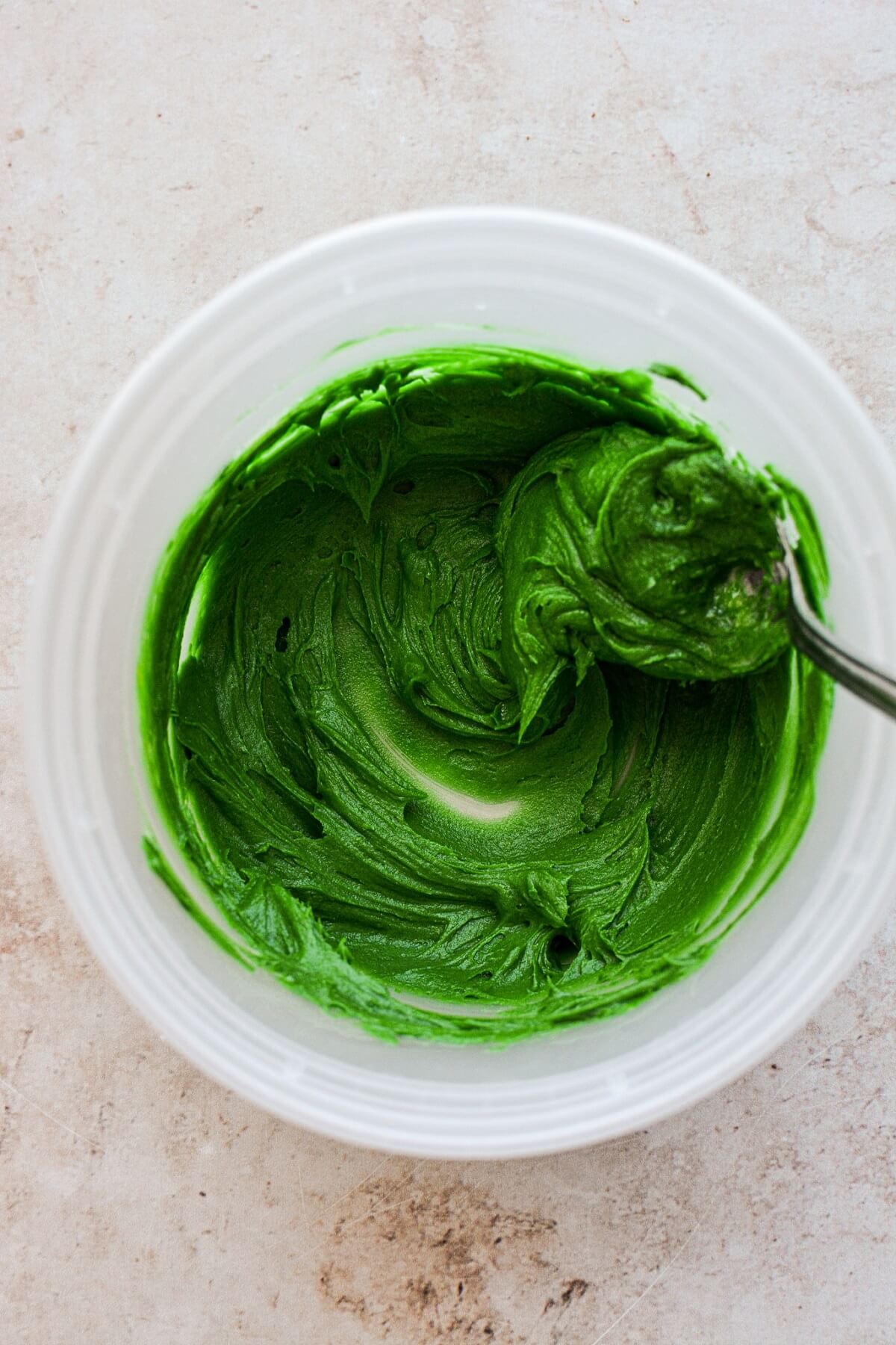Bowl of green frosting.
