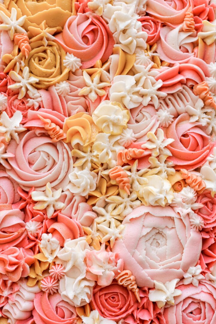 Step 7 for decorating a carrot cake sheet cake with buttercream flowers.