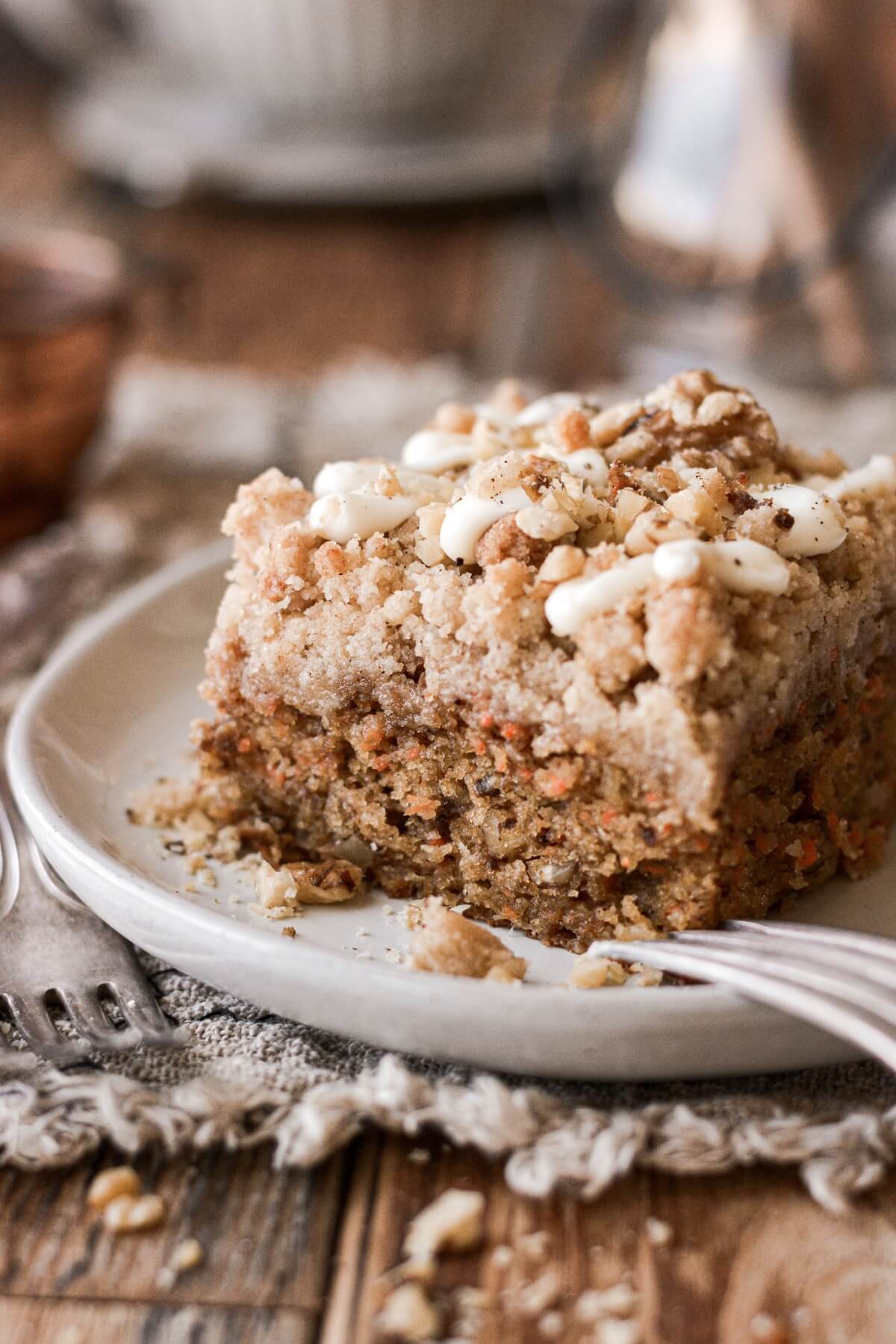 A piece of carrot crumb cake on a plate.