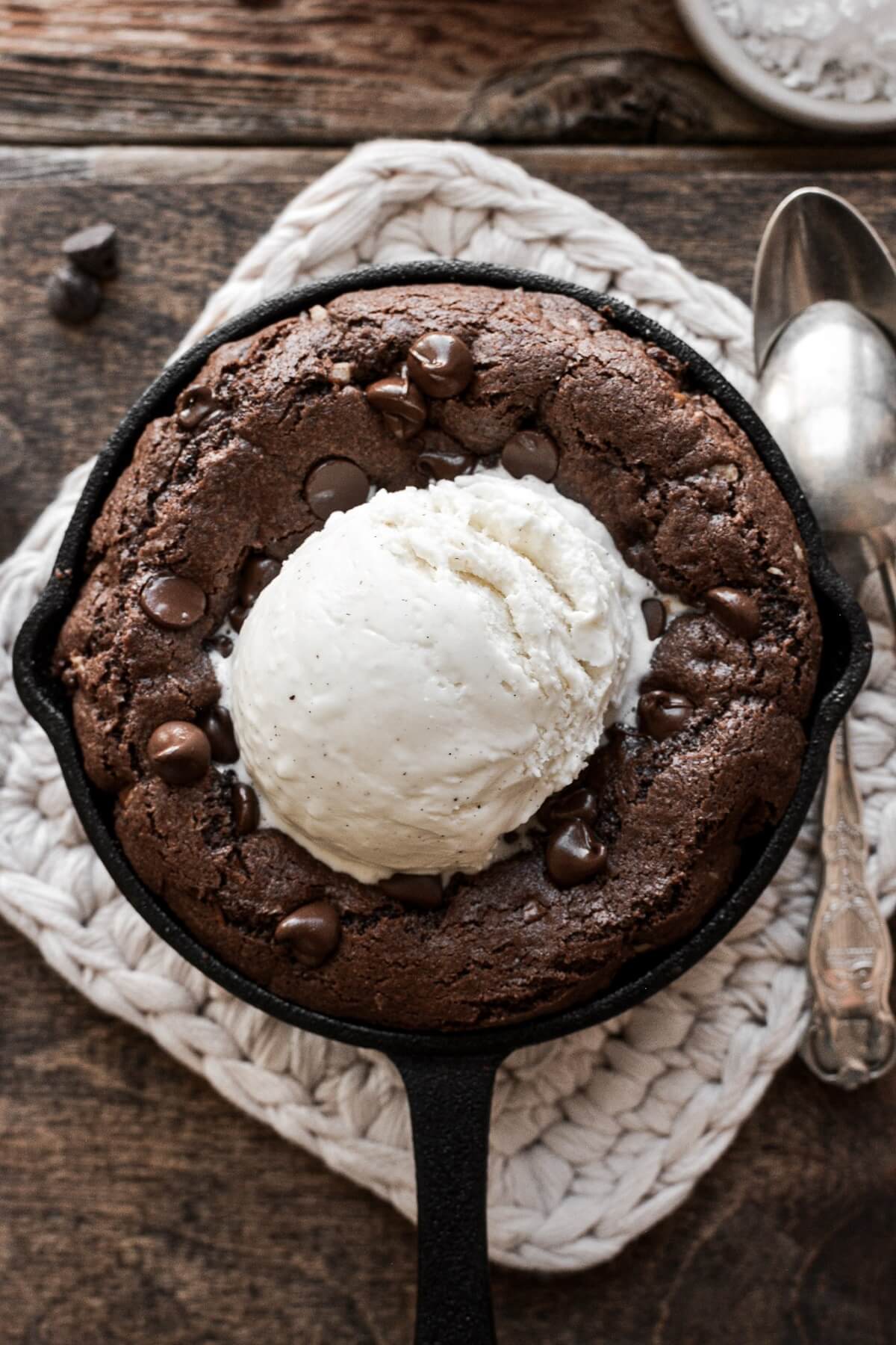 Mini double chocolate skillet cookie topped with a scoop of ice cream.