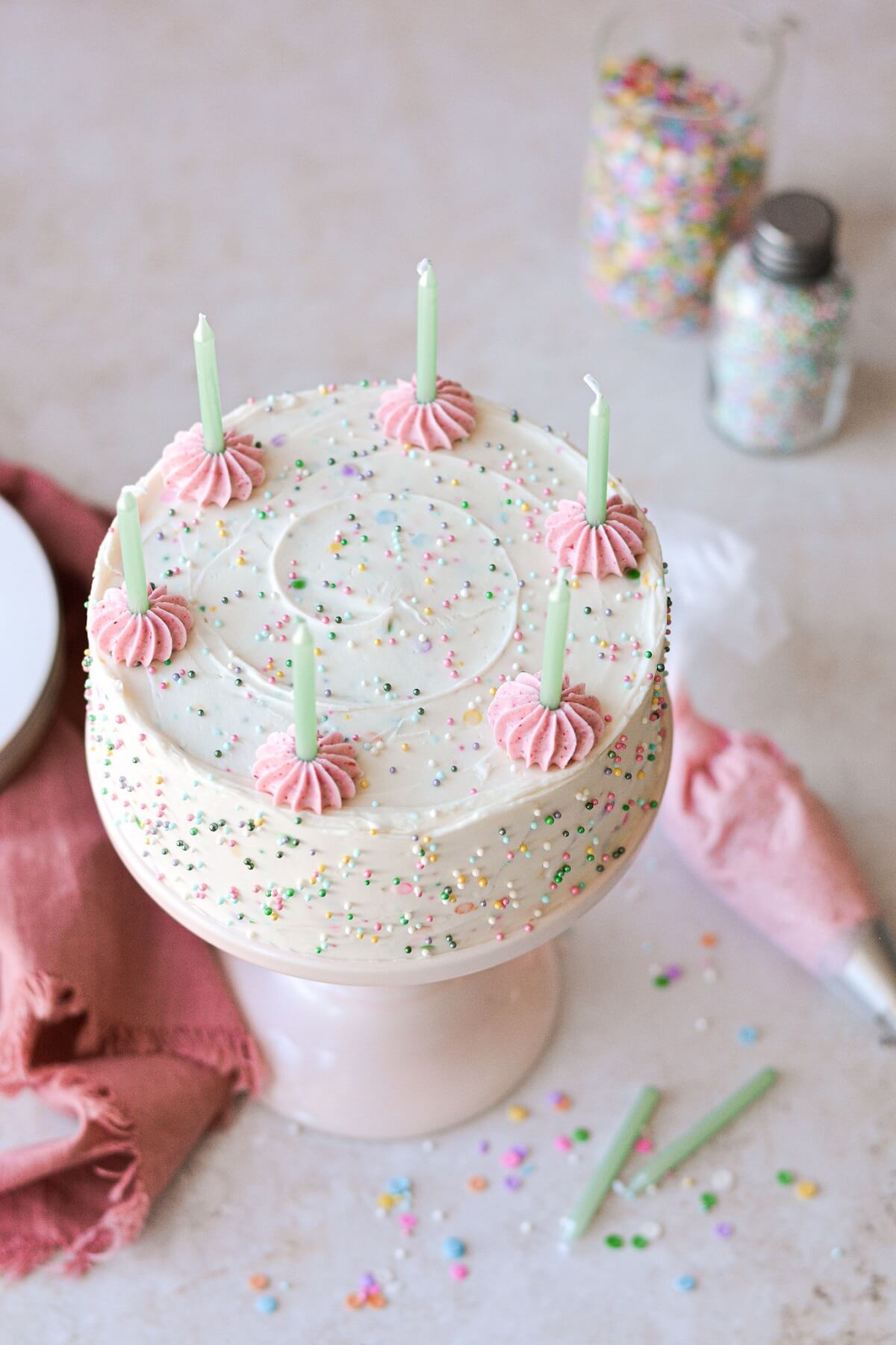 Mini funfetti cake with green birthday candles.