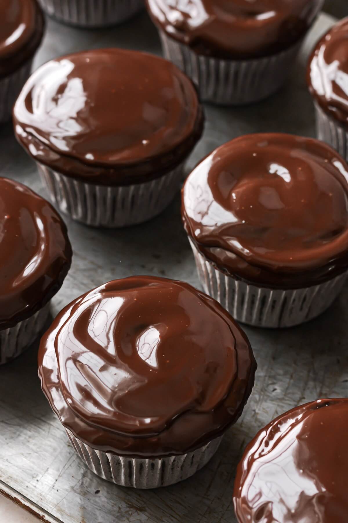 Chocolate cupcakes dipped in ganache.