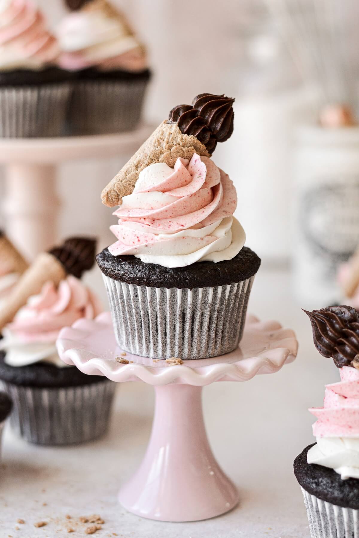 Neapolitan cupcake on a mini pink cupcake stand.