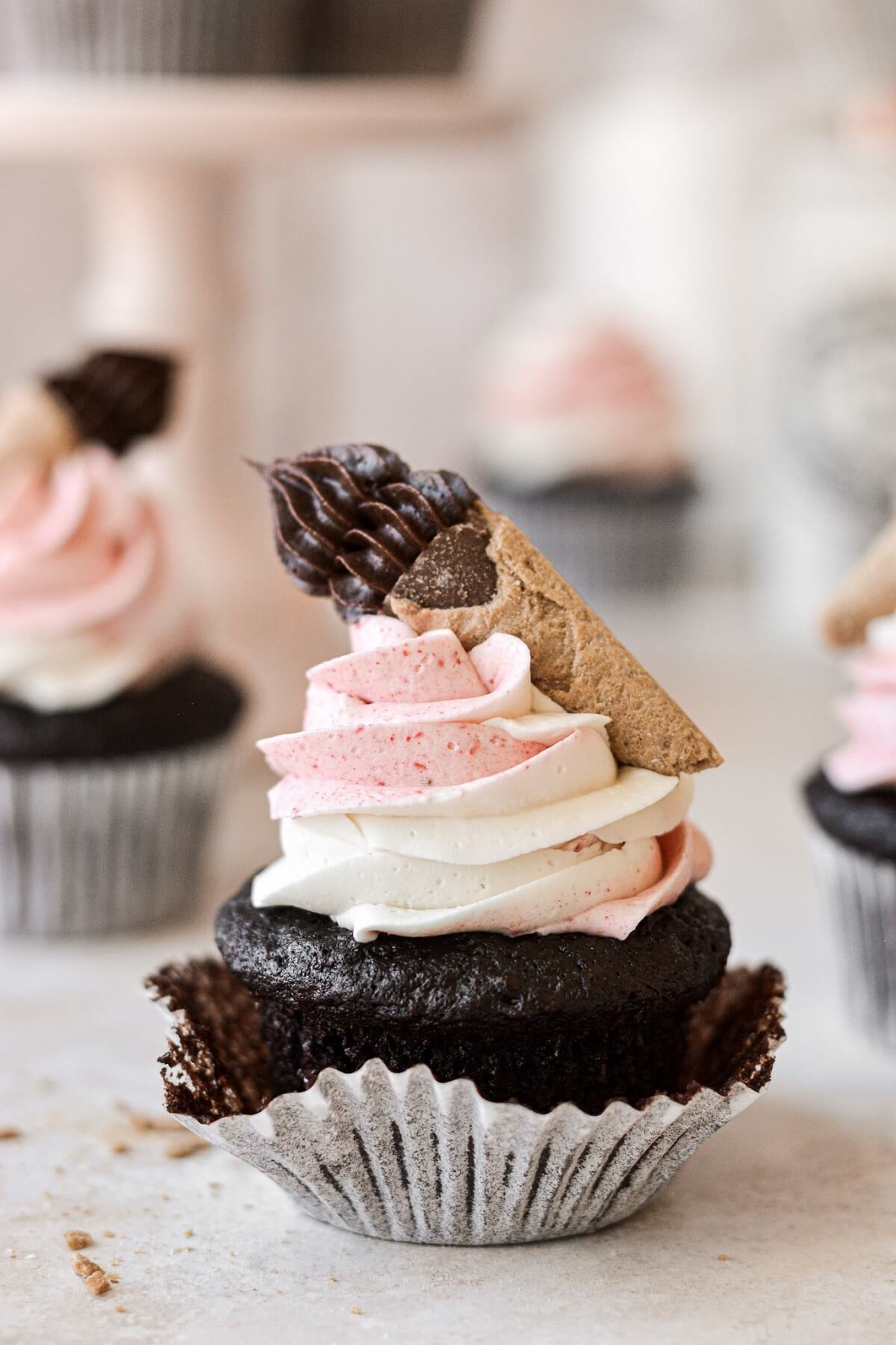 Neapolitan cupcake with the wrapper pulled back.