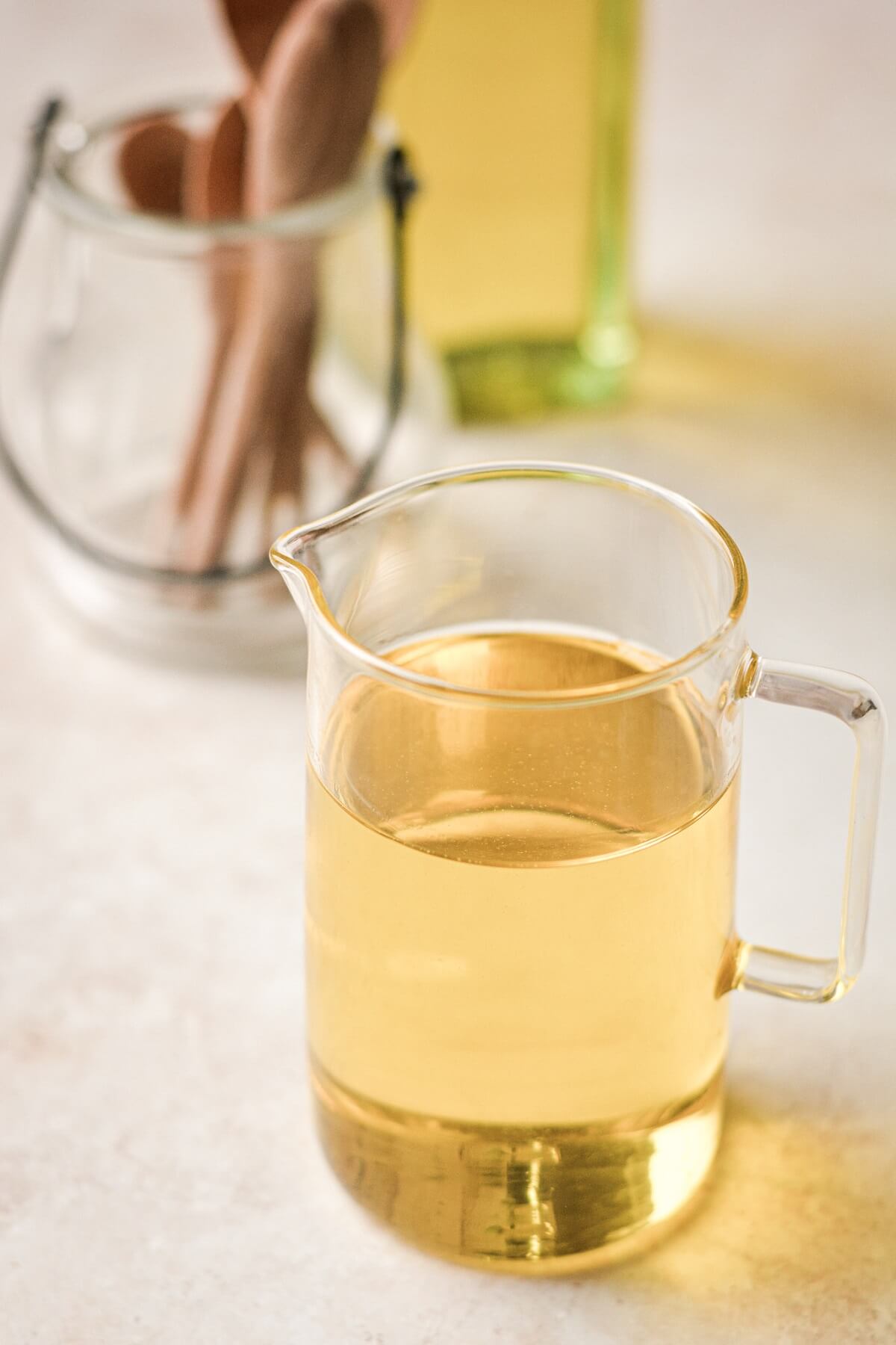 Glass pitcher of olive oil.