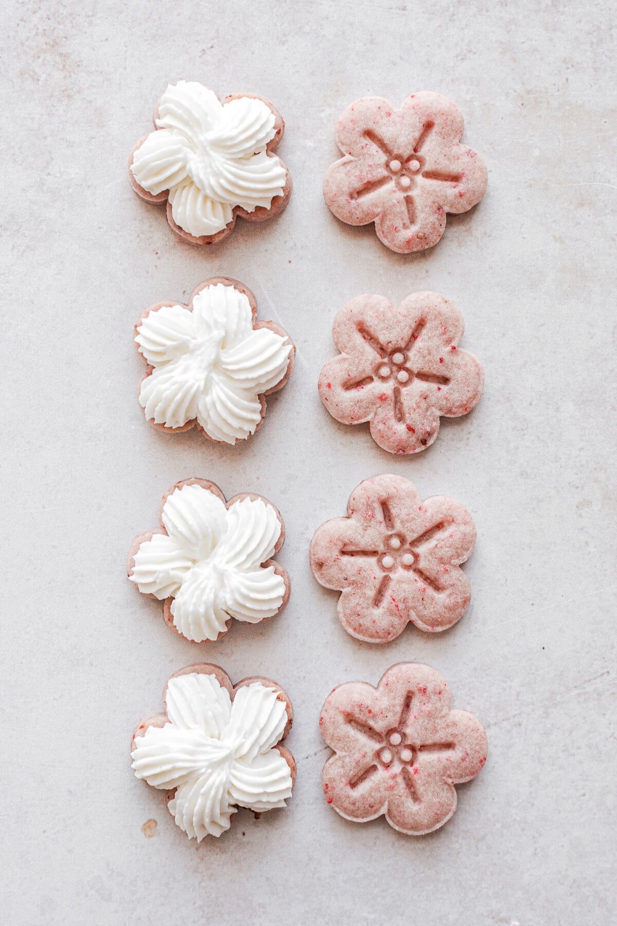 Flower shaped strawberry cookies filled with lemon buttercream.