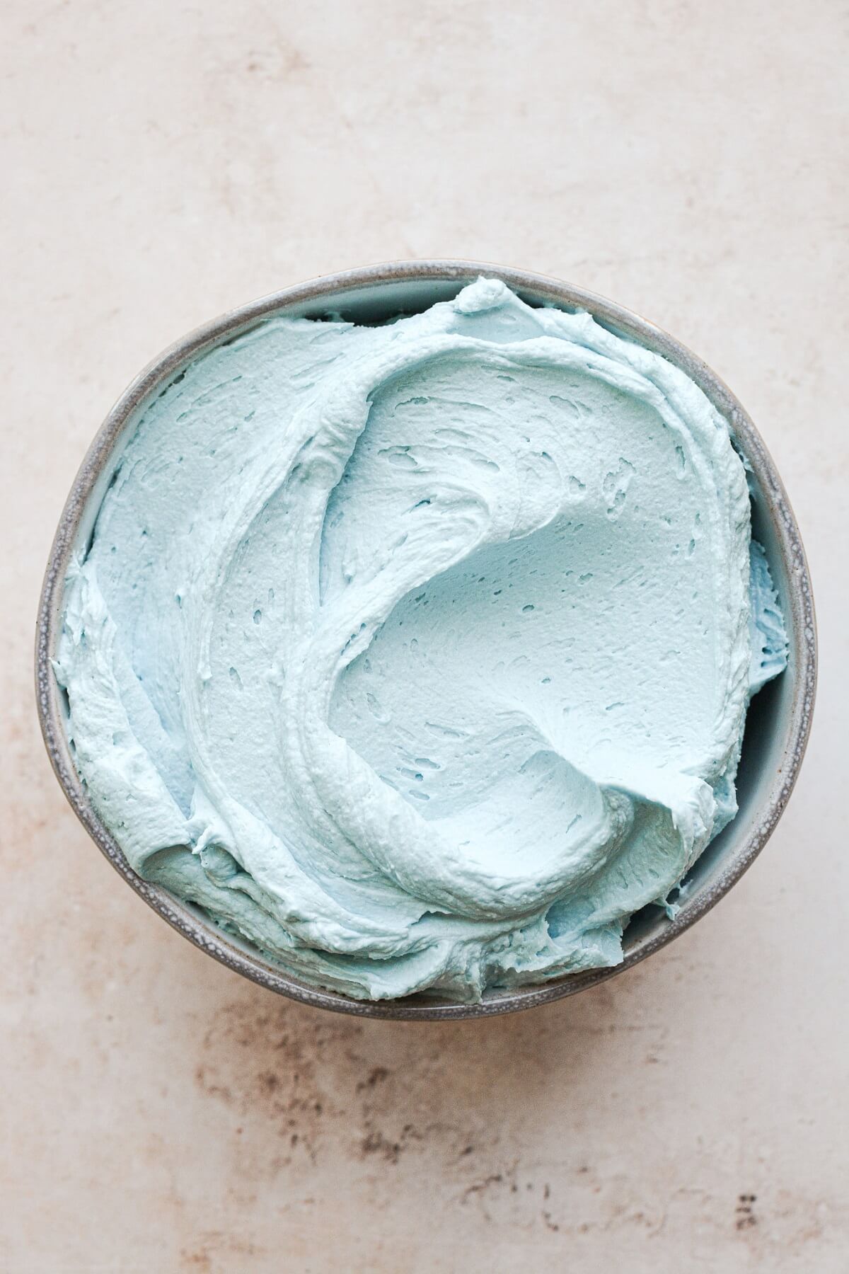 Bowl of blue malted milk buttercream.