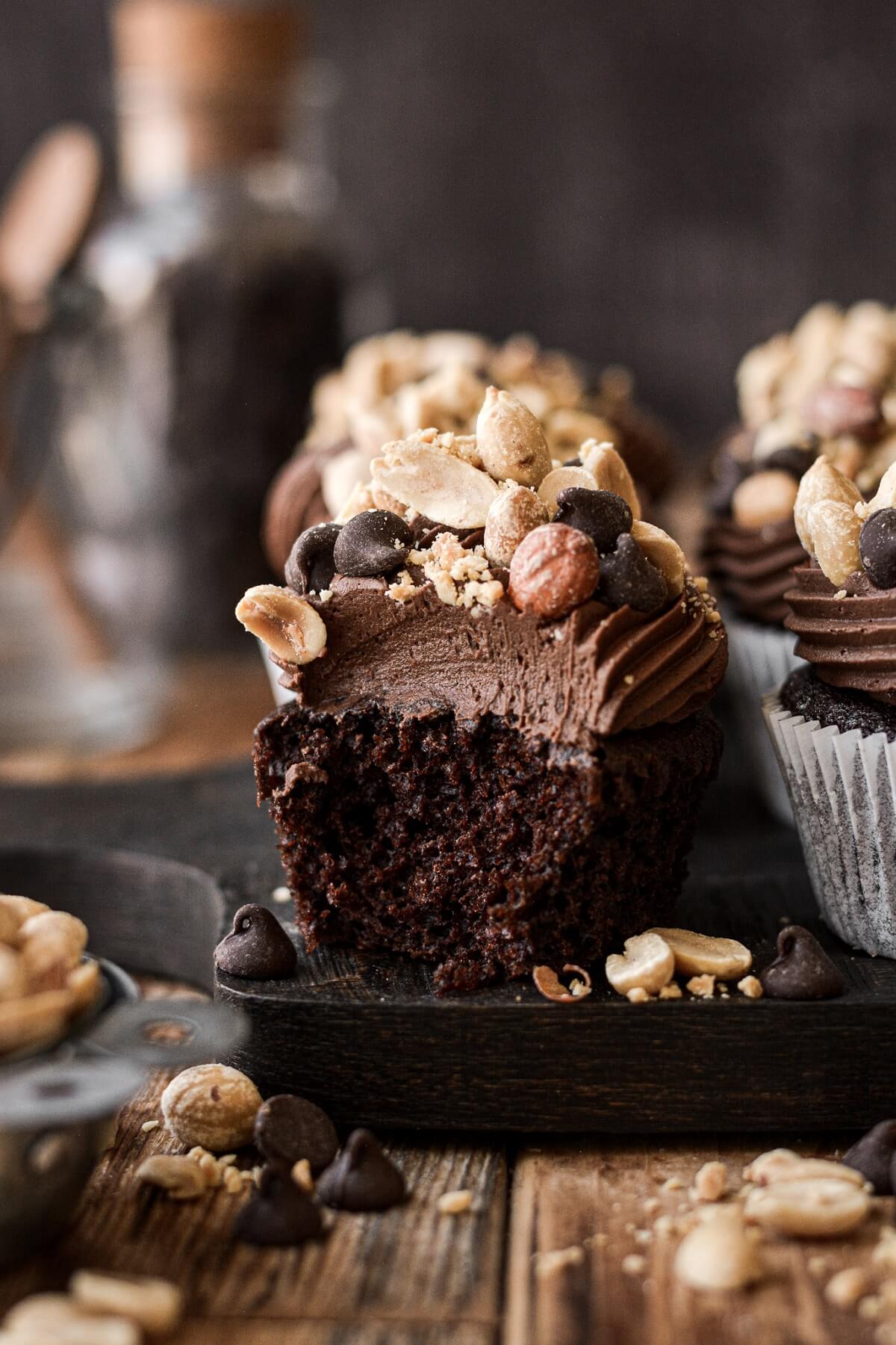Chocolate peanut cluster cupcake with a bite taken.