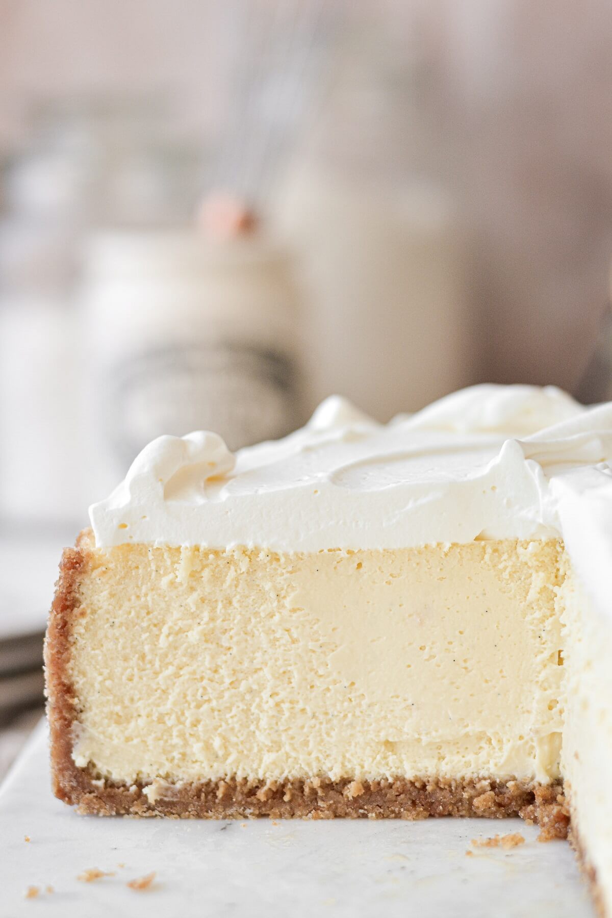 Creamy vanilla cheesecake topped with whipped cream.