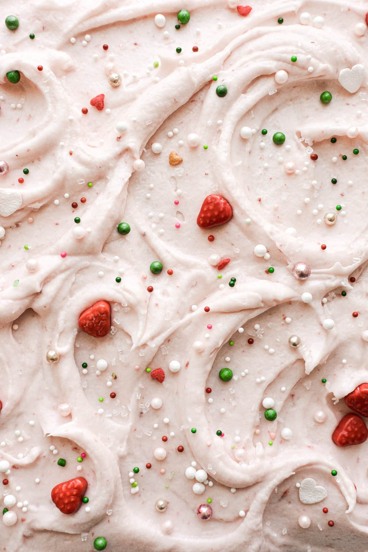 Strawberry cream cheese frosting with strawberry sprinkles.